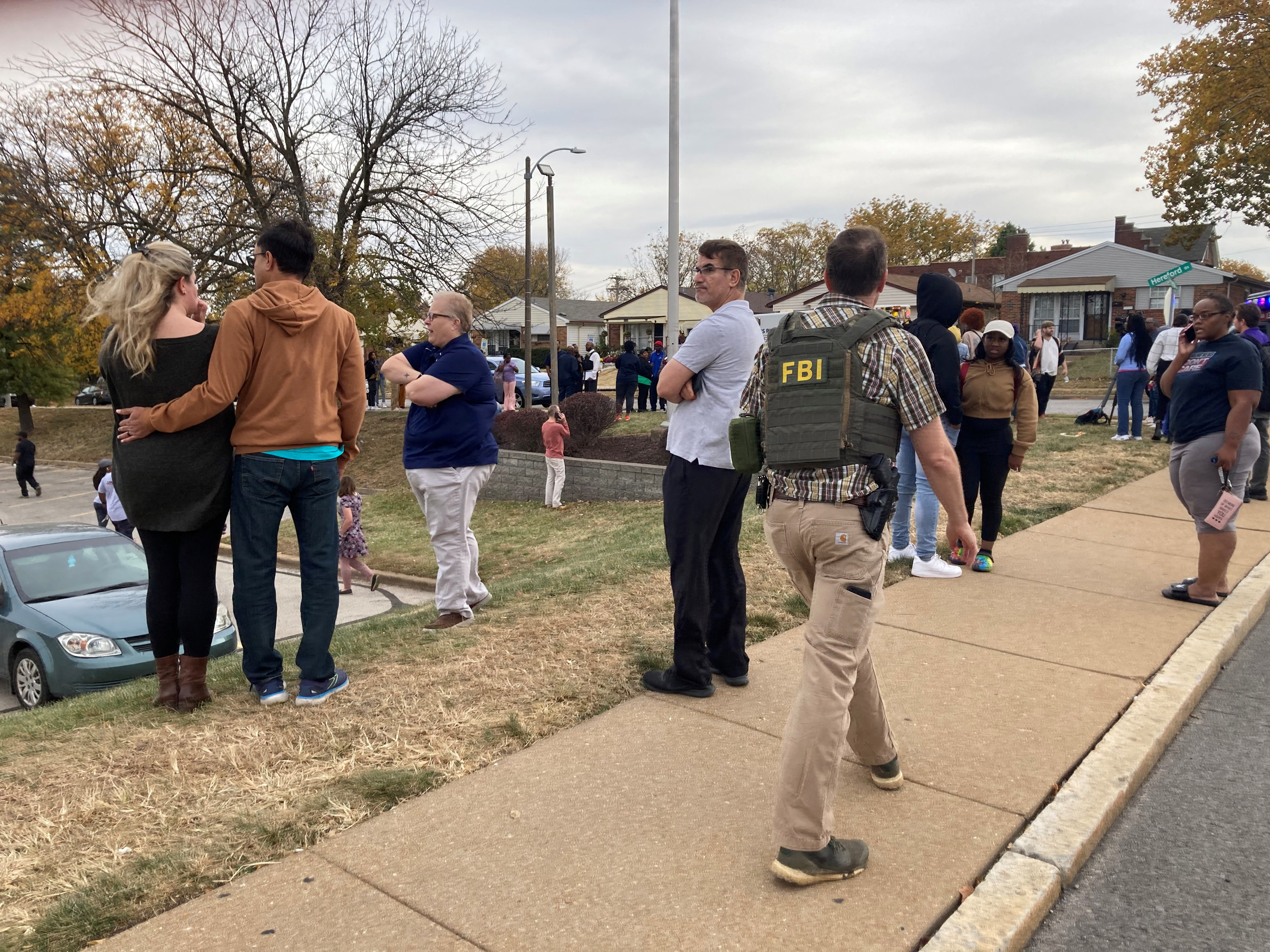 People gather following a shooting at a high school, in St. Louis, Oct. 24, 2022, in this still image.