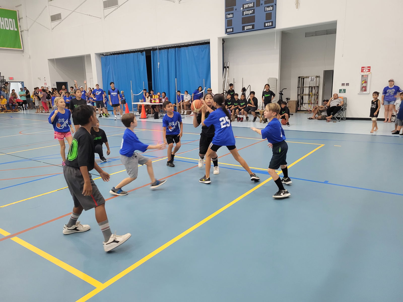 A KOB 2 player gathers for the shot as an SIS 1 defender closes in during an elementary school division game of the IT&E Interscholastic Basketball League at the MHS gym on Saturday.