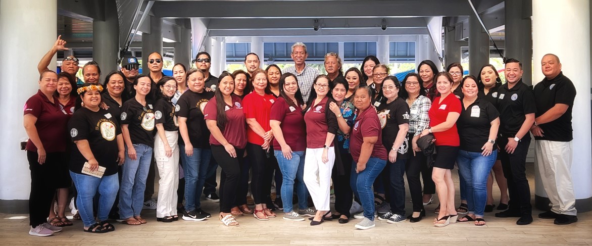 Officials and employees of the Public School System’s Federal Programs Office, Finance and Budget, Procurement and Supply, and Human Resources Office pose for a photo with acting Commissioner of Education Eric Magofna, right, prior to the start of a day-long professional development session called “Building A Culture of Continuous Improvement” at the Pacific Islands Club on Friday.