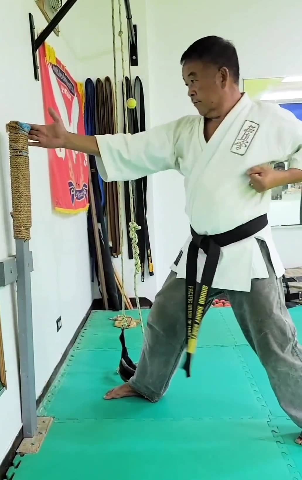 Kyokushin Karate Sensei Danny Banez demonstrates the use of a makiwara board.