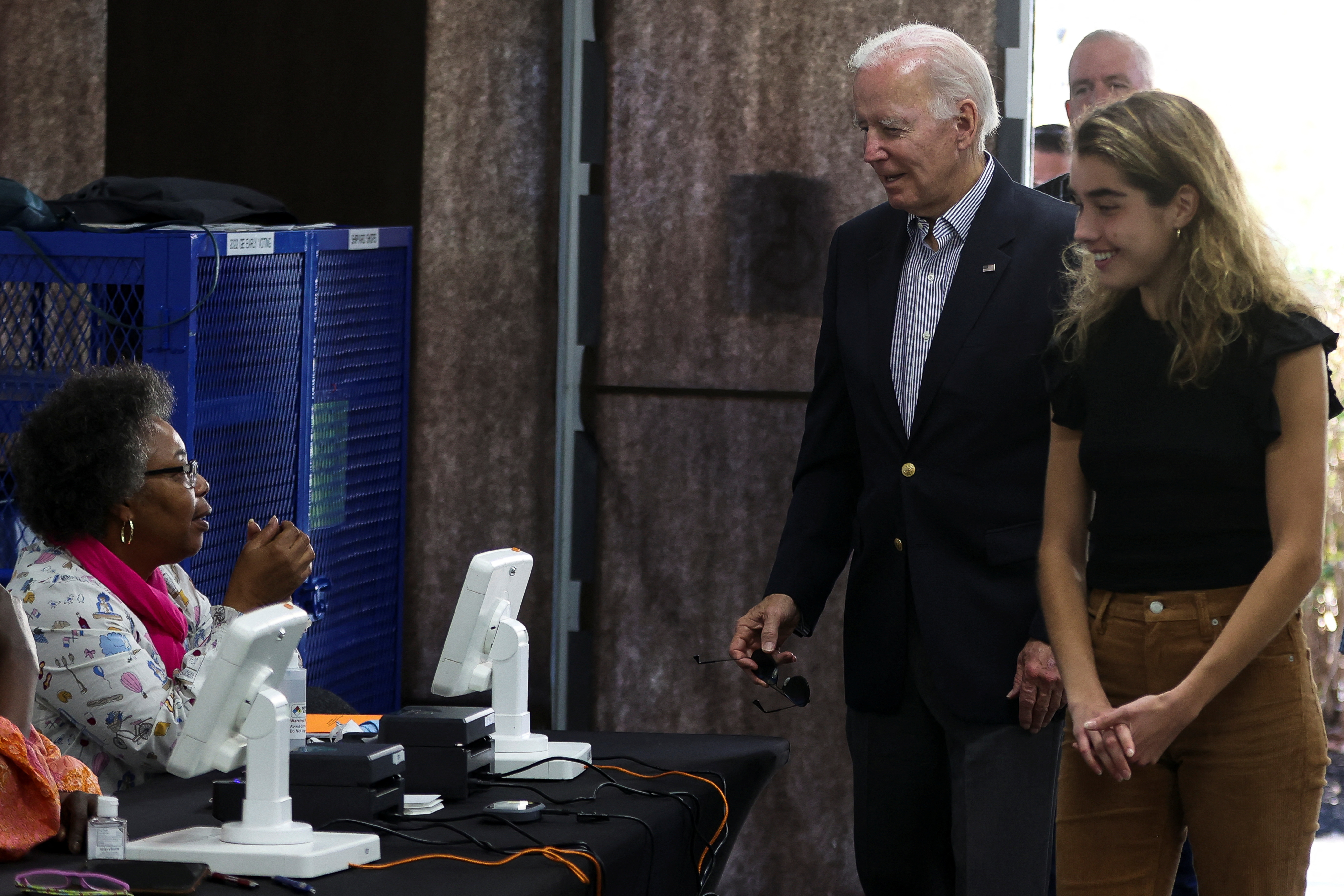 President Joe Biden arrives to cast his vote during early voting for the 2022 midterm elections with his granddaughter Natalie, a first-time voter, at a polling station in Wilmington, Delaware, Oct. 29, 2022.