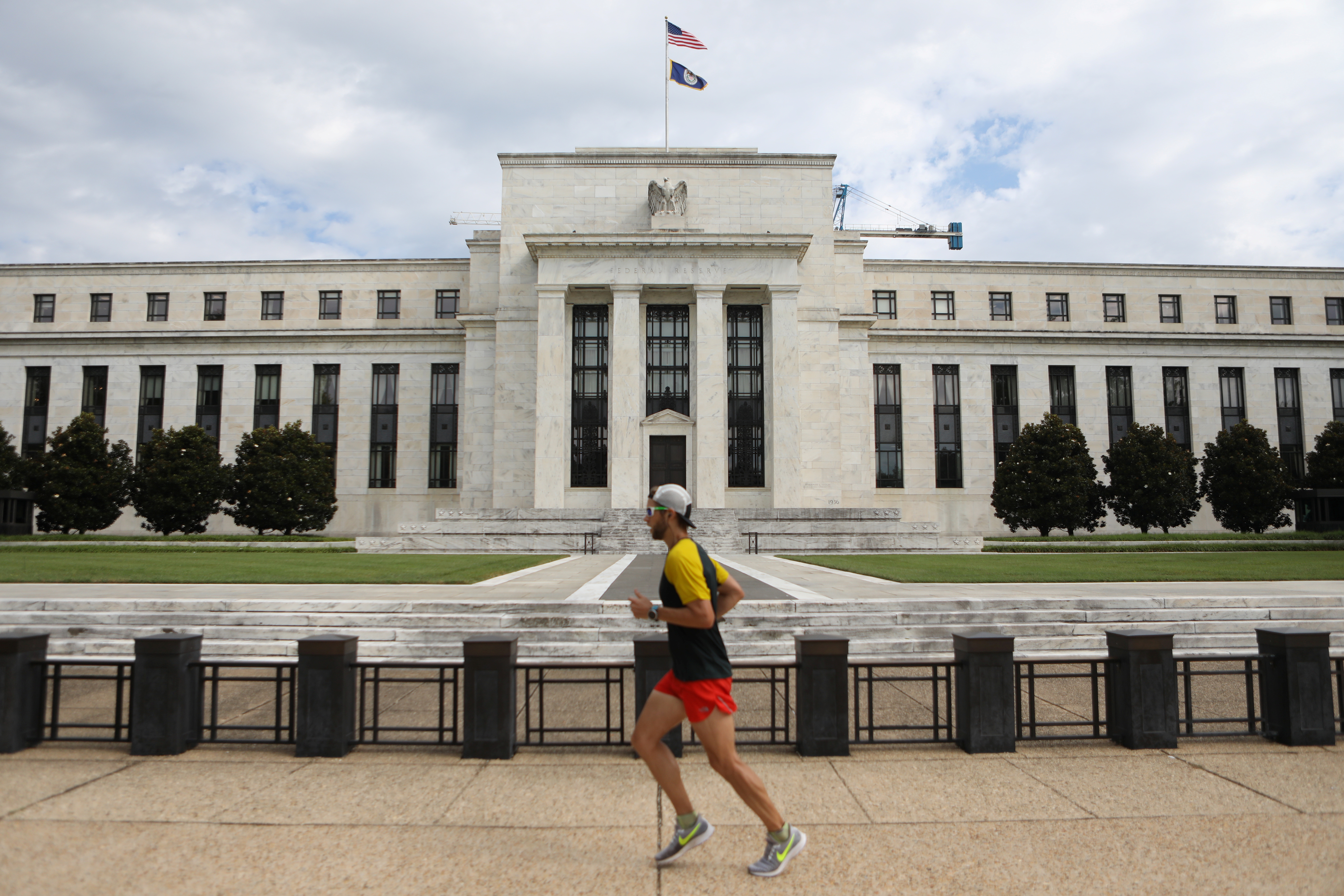 A jogger runs past the Federal Reserve building in Washington, D.C., Aug. 22, 2018.