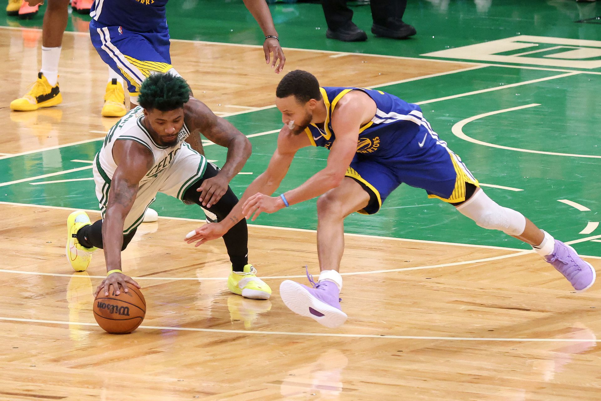 Boston Celtics guard Marcus Smart (36) and Golden State Warriors guard Stephen Curry (30) reach for a loose ball during the fourth quarter of game six in the 2022 NBA Finals at the TD Garden in Boston, Massachusetts on June 16, 2022.