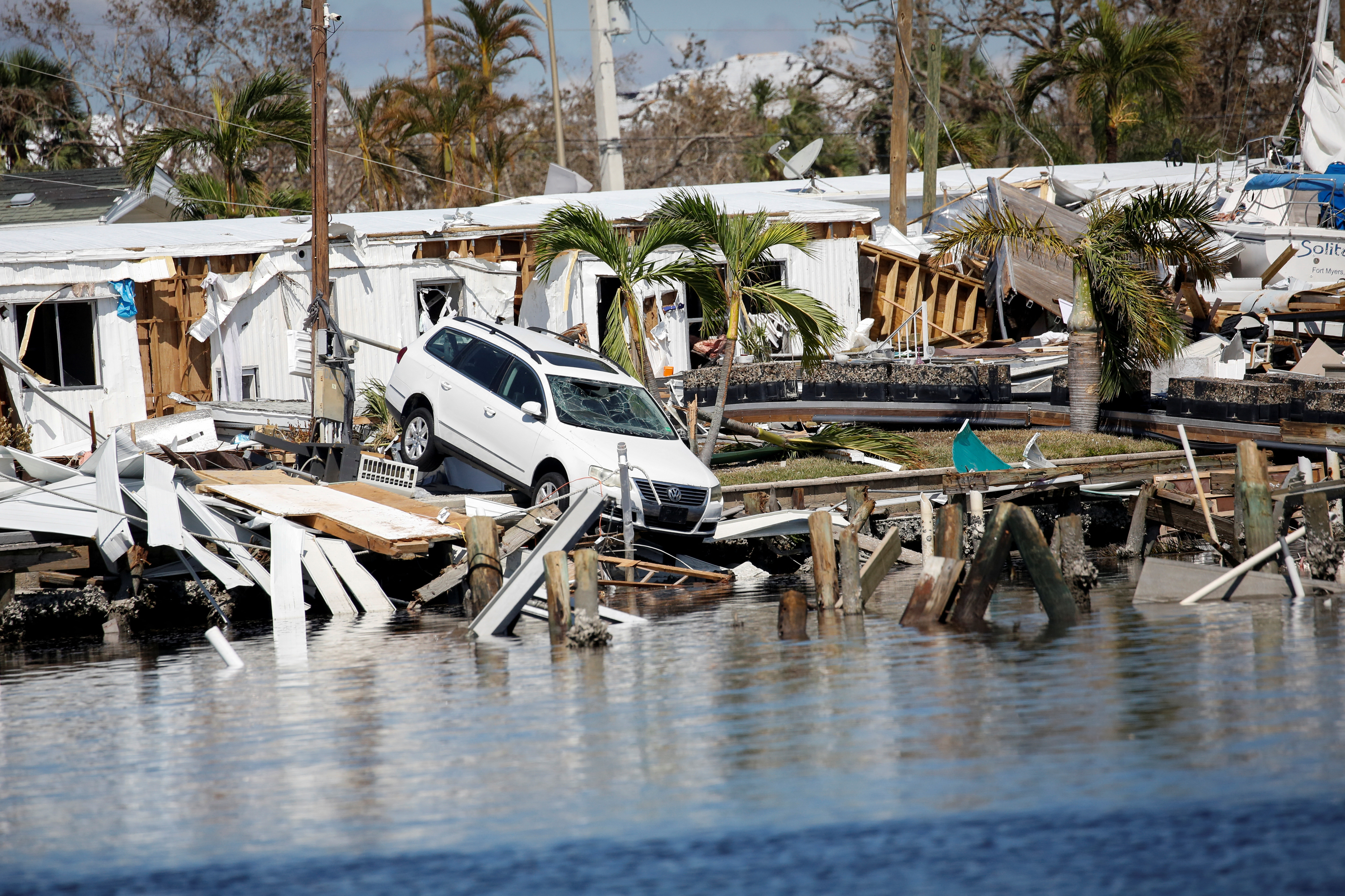 A destroyed car is seen in the Matanzas Pass after Hurricane Ian caused widespread destruction in Fort Myers Beach, Florida, Oct. 1, 2022.