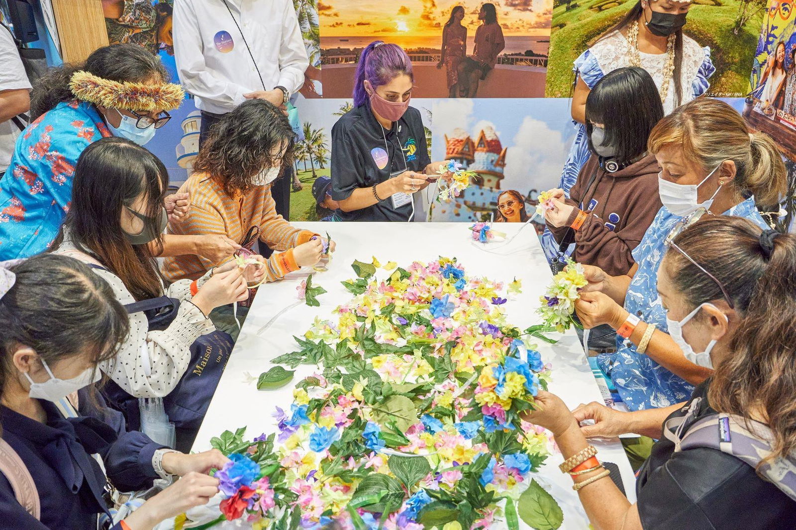 Whilhelmina Marciano, standing left, teaches mwar-making at the Marianas booth at JATA Tourism Expo 2022 held on Sept. 22-25, 2022, in Tokyo, Japan.