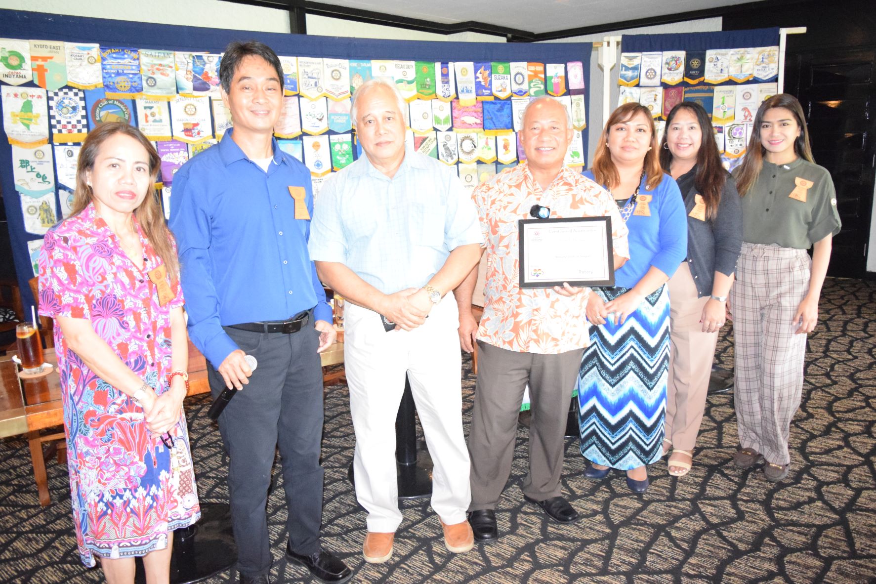 Department of Commerce-Economic Development Division Director Jesus Taisague, center, and fishing industry development officer Herman Sablan, third left, pose for a photo with Rotary Club of Saipan President Wendell Posadas, second left, and other Rotarians during their luncheon meeting at the Hyatt Regency Saipan's Giovanni's Restaurant on Tuesday.
