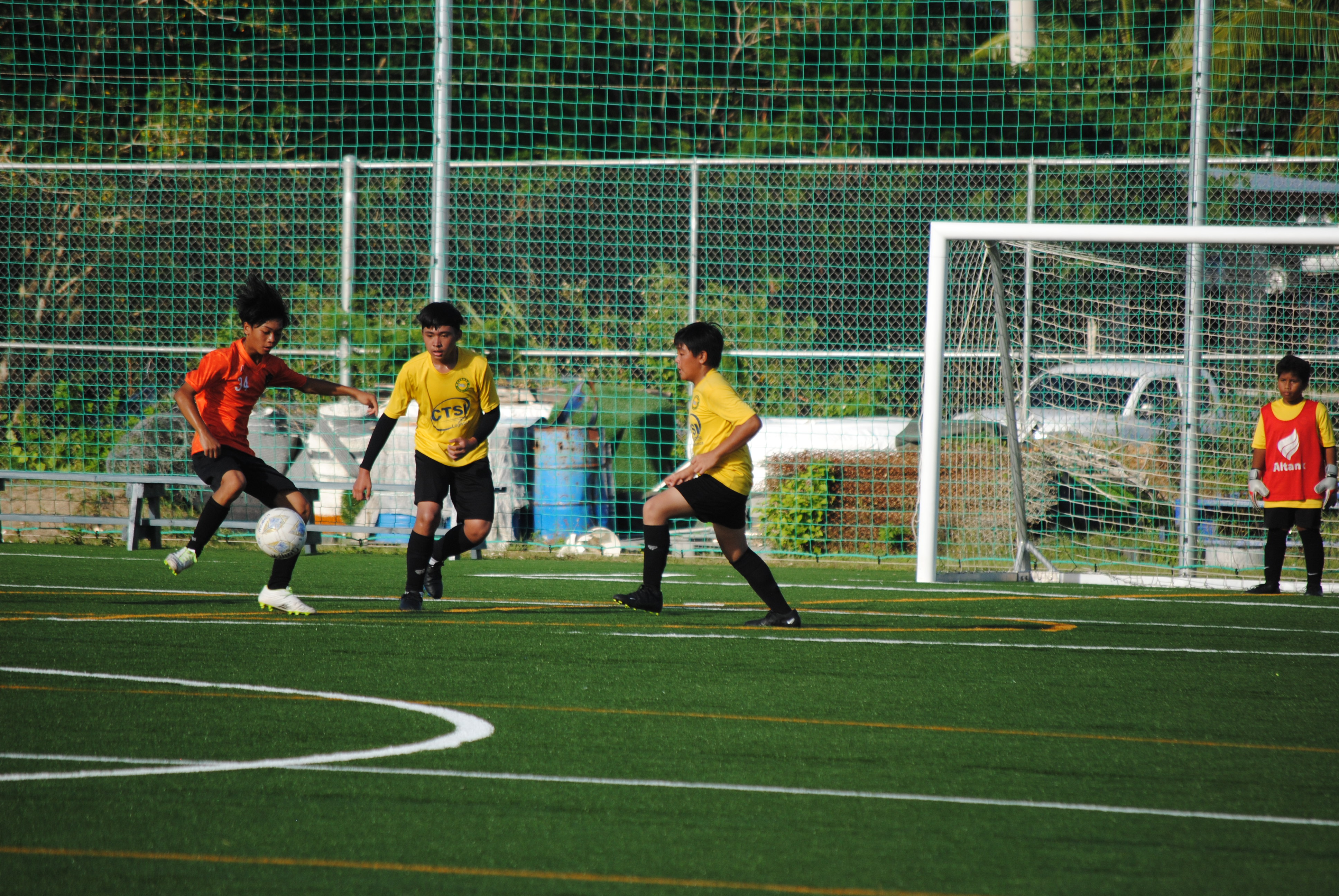 Kanoa’s Akoni Matsumoto sets up for the shot as two defenders close in during a U13 Boys Division game of the TakeCare Youth Soccer League Saturday at the NMI Soccer Training Center.