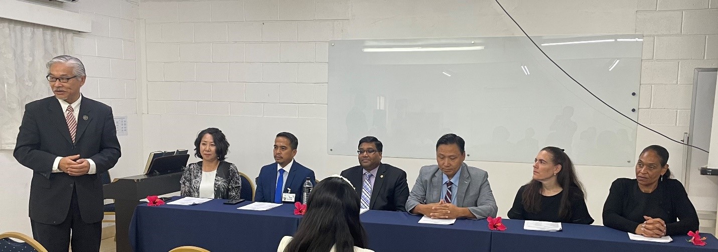 EUCON International University President Dr. Christian Wei, left standing, speaks during a meeting with members of the Transnational Association of Christian Colleges and Schools or TRACS evaluation team.