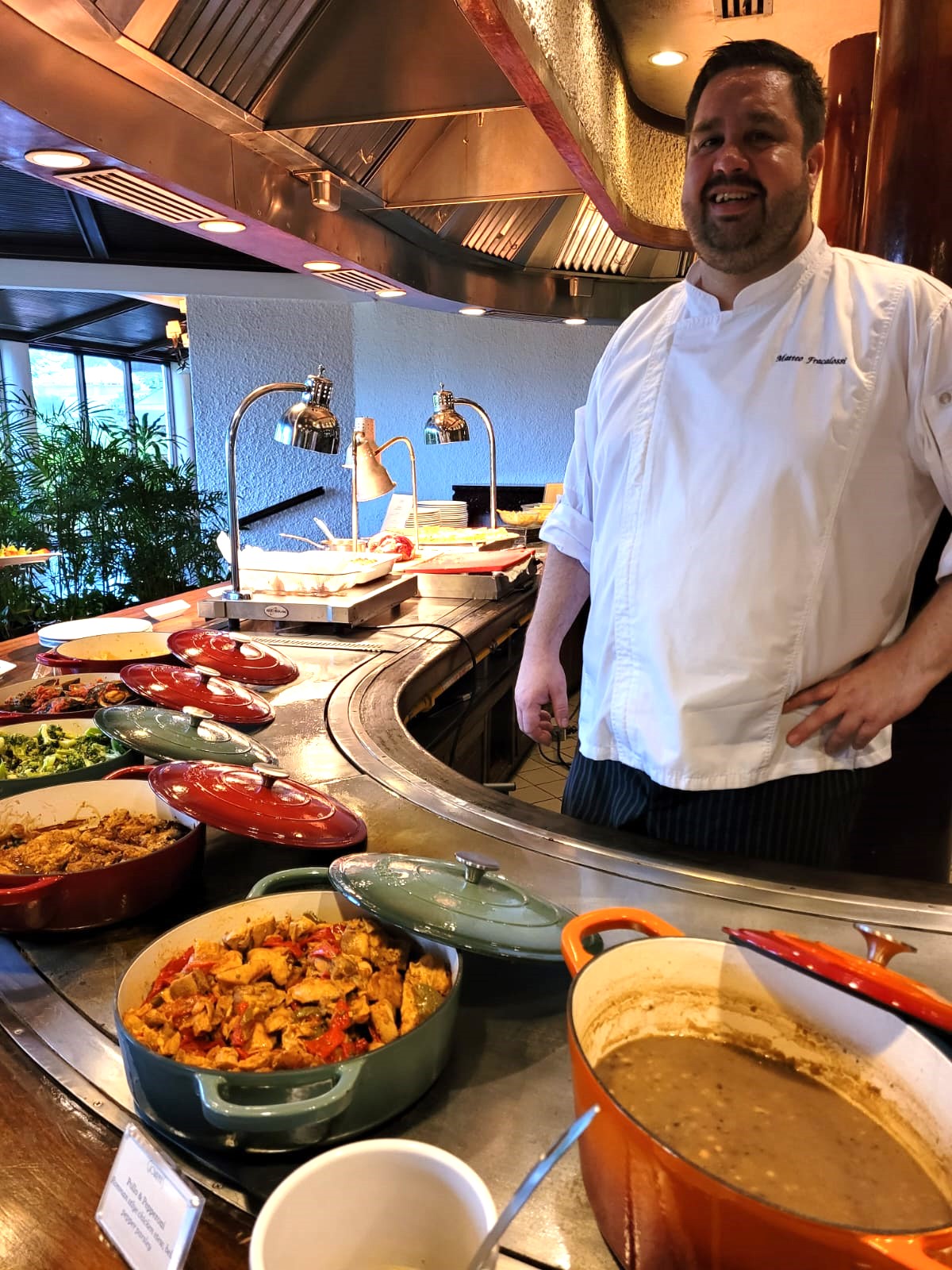 Giovanni's Restaurant's Executive Chef Matteo Fracalossi stands next to an Italian soup, mesciua and other Italian dishes.