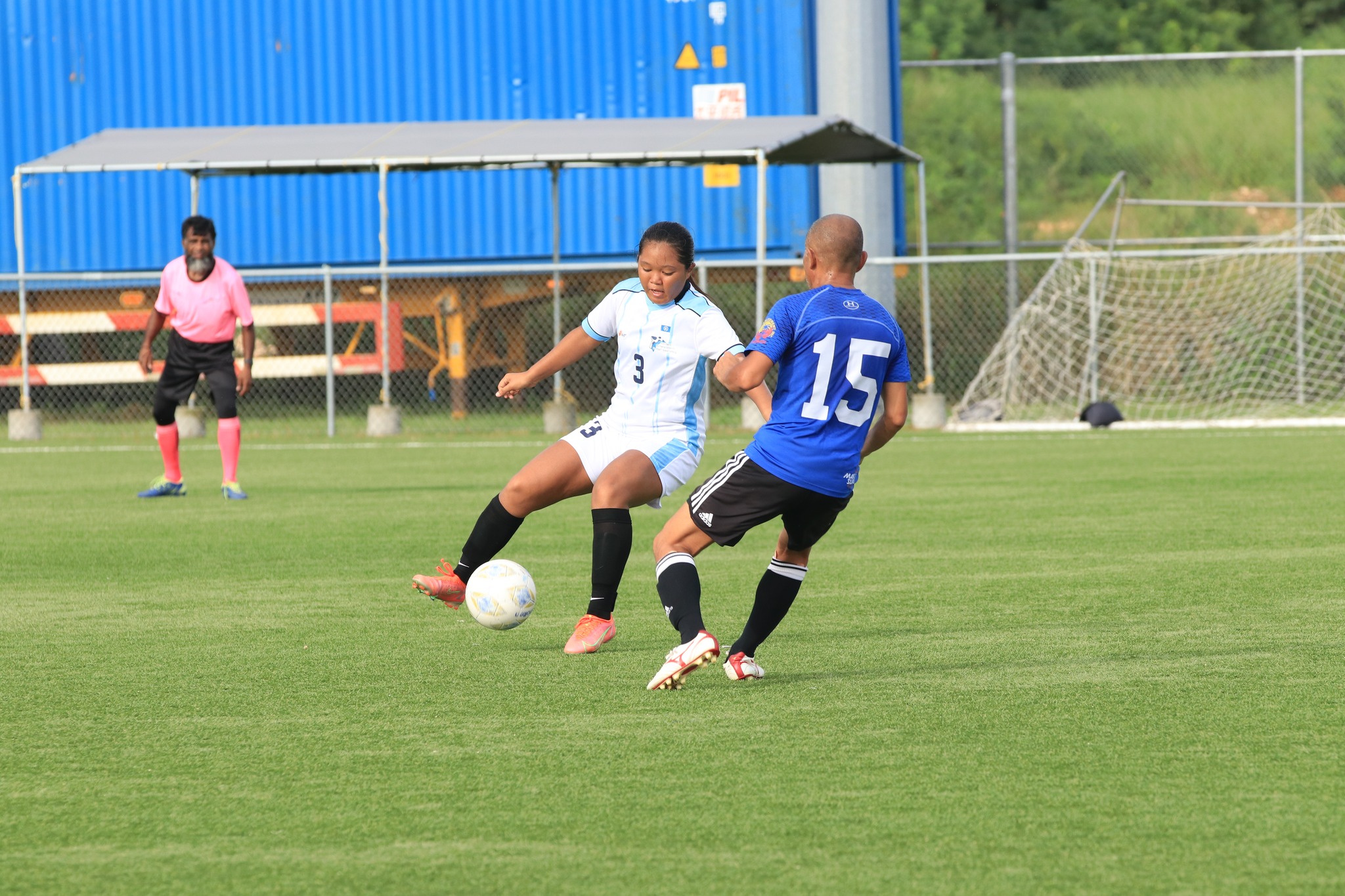 WNT Development Team's Nathanette Camacho tries to shake off a defender during a Division B  game of the Marianas Soccer League at the NMI Soccer Training Center.