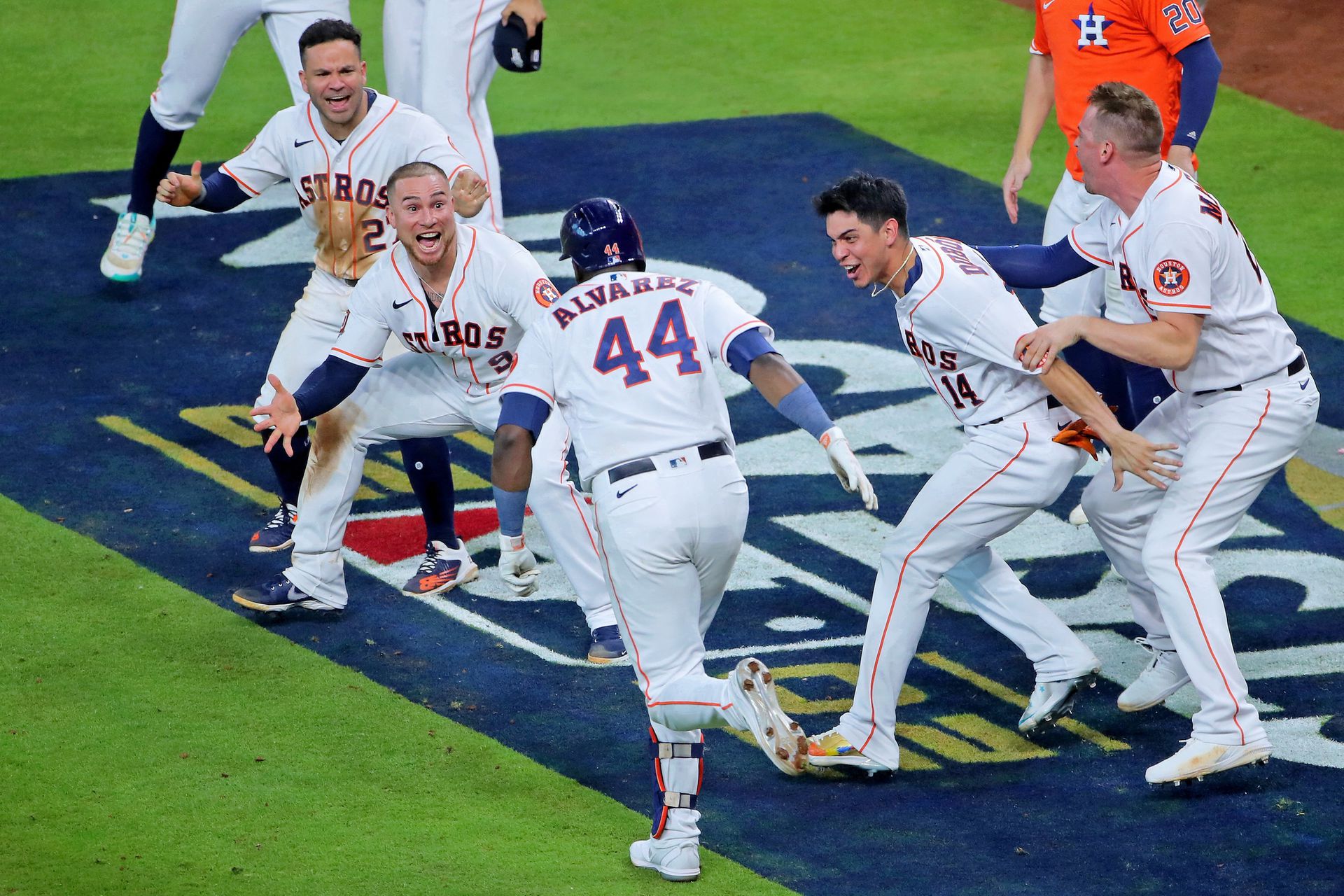 Houston Astros second baseman Jose Altuve (top) and catcher Christian Vazquez (9) and center fielder Mauricio Dubon (14) celebrate after designated hitter Yordan Alvarez (44) hit a walk-off three-run home run against the Seattle Mariners during the ninth inning in game one of the ALDS for the 2022 MLB Playoffs at Minute Maid Park in Houston, Texas, Oct. 11, 2022.