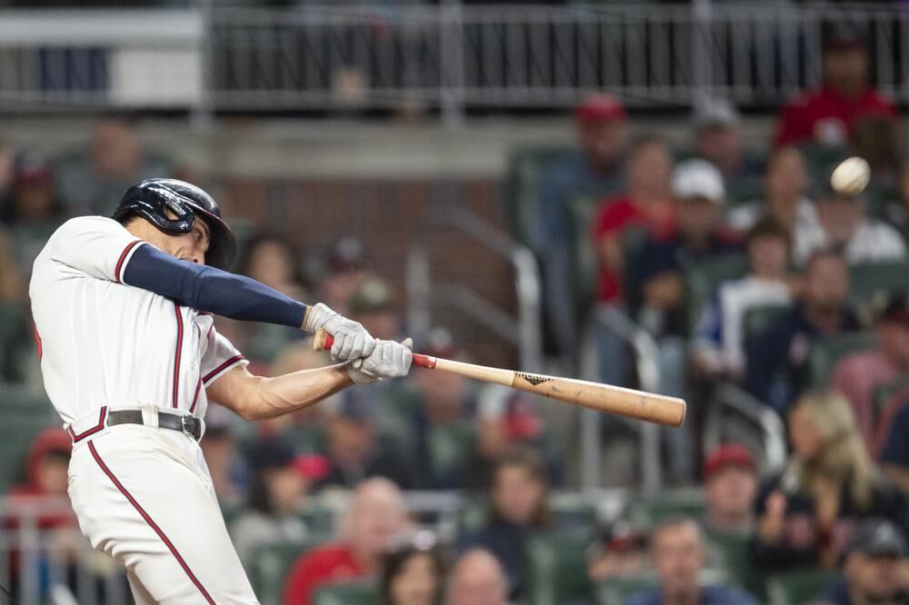 Atlanta Braves Matt Olson hits a home run in the sixth inning of a baseball against the New York Mets, Sunday, Oct. 2, 2022, in Atlanta.