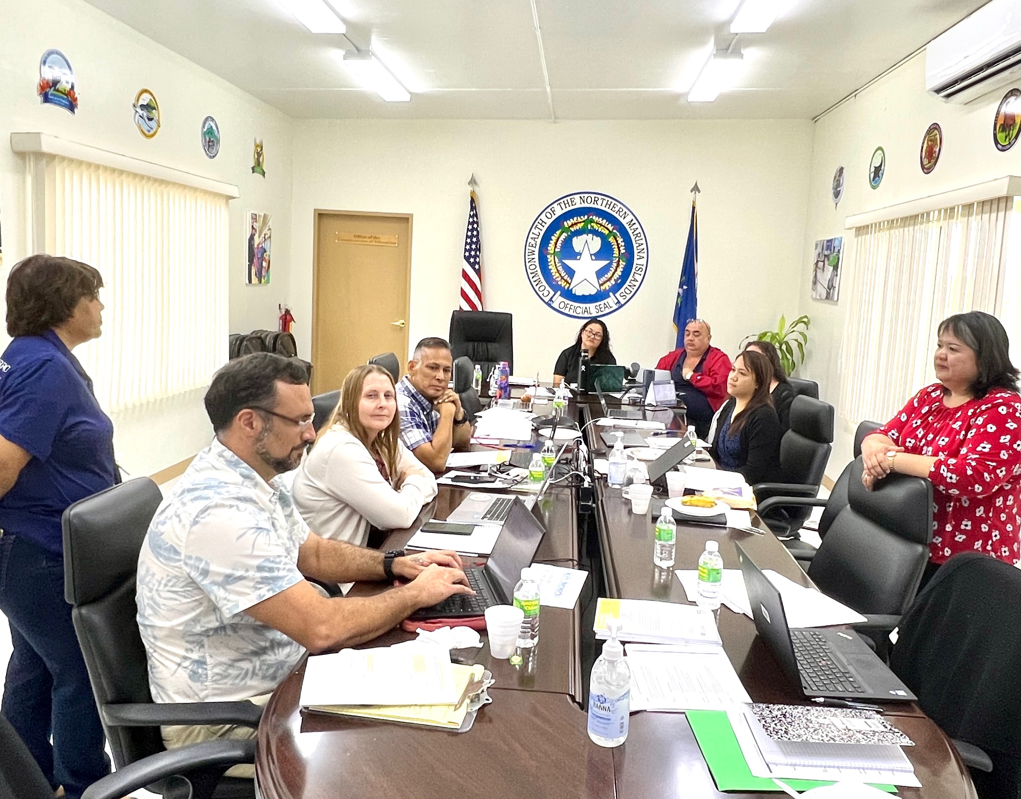 Senior Director for Curriculum and Instruction Jackie Quitugua, standing left, and Senior Director for Accountability Research and Evaluation Dr. Rizalina Liwag, standing right, participate in a REL Pacific training session at the Office of the Commissioner of Education.