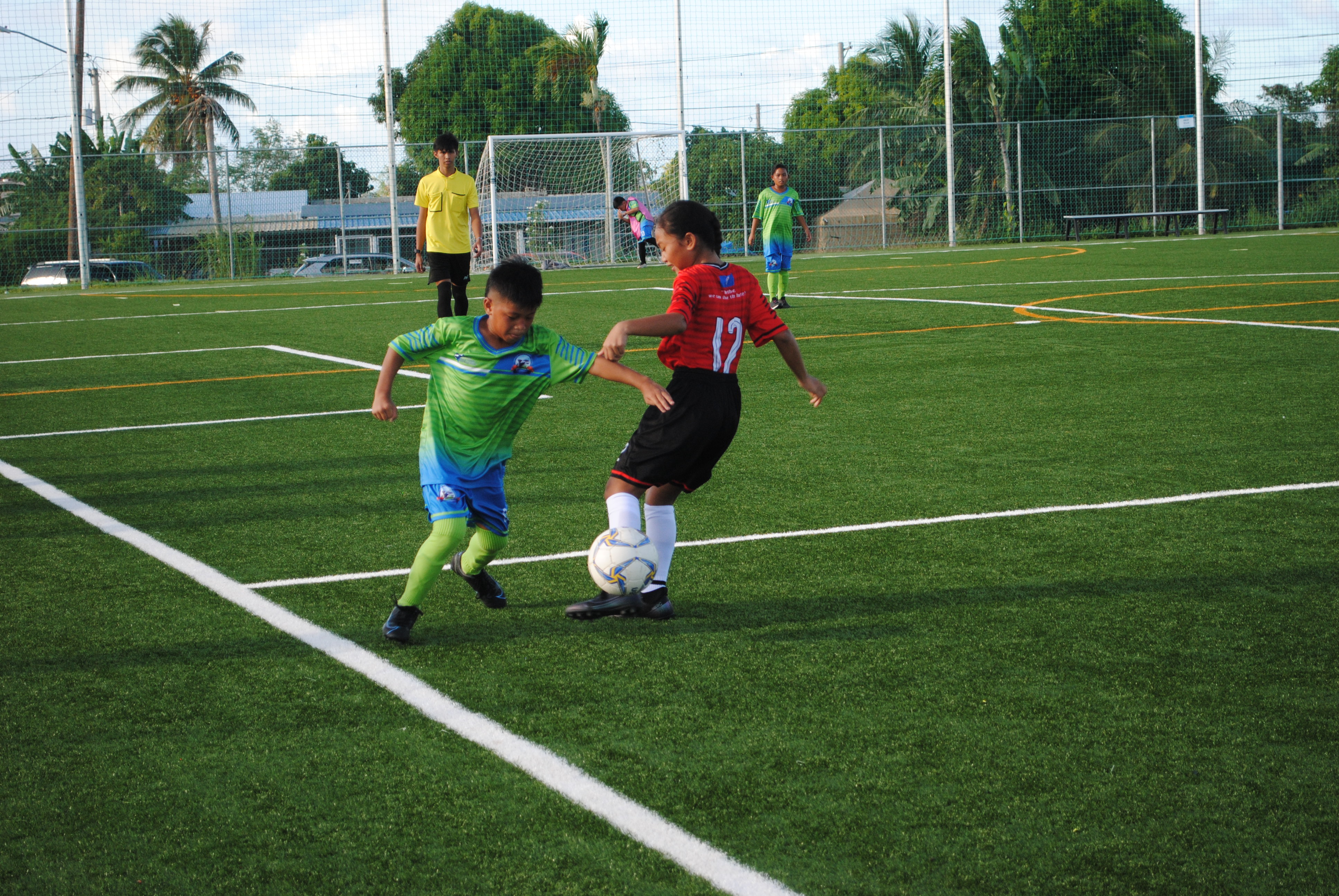 Landin ReyesKoES 1's Landin Reyes slips past a defender during an elementary school division game of the NMIFA-PSS Interscholastic Soccer League at the NMI Soccer Training Center.