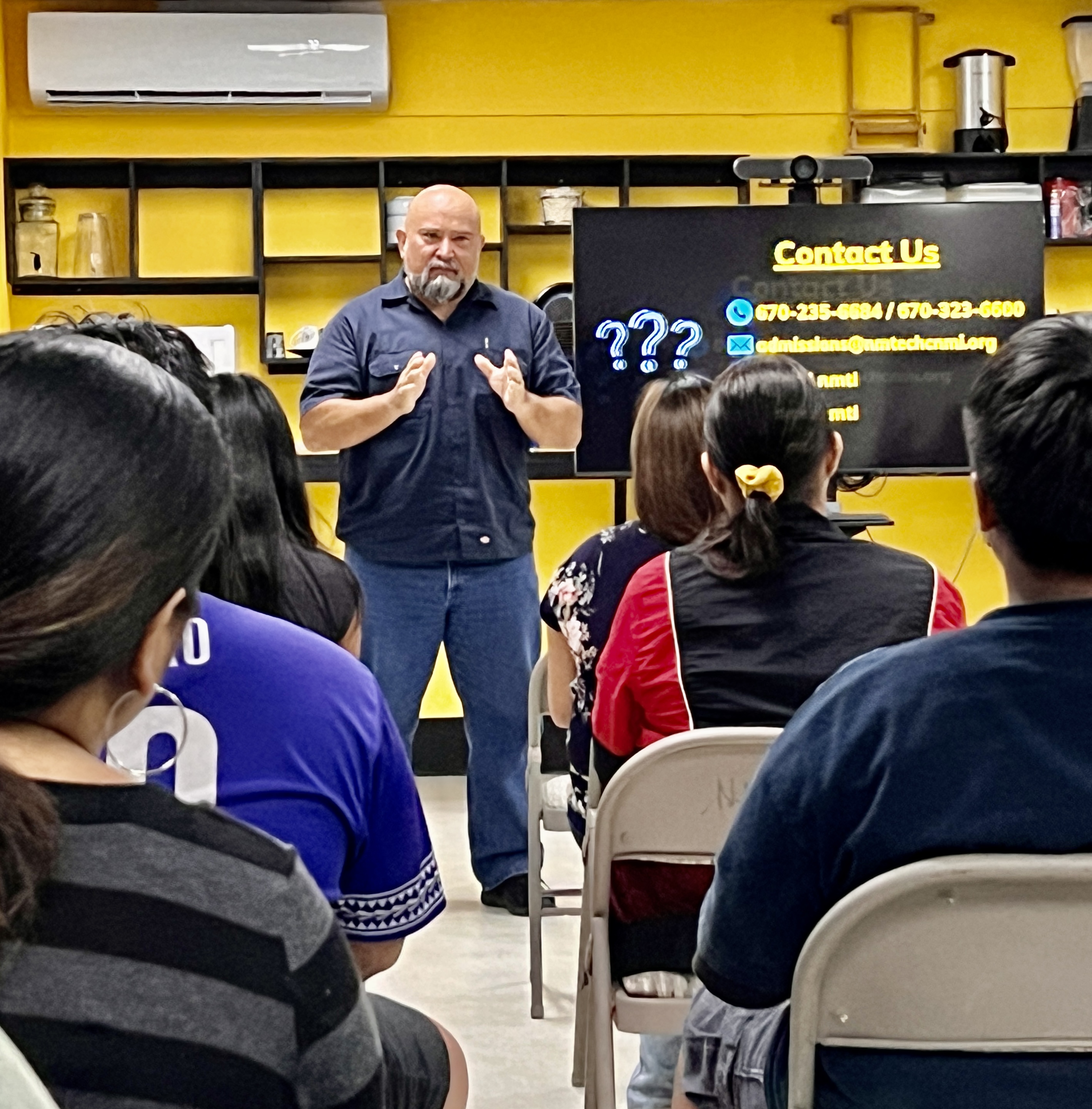 NMTech instructor Luis Deleon Guerrero provides Tanapag Middle School students a snapshot of the construction class.