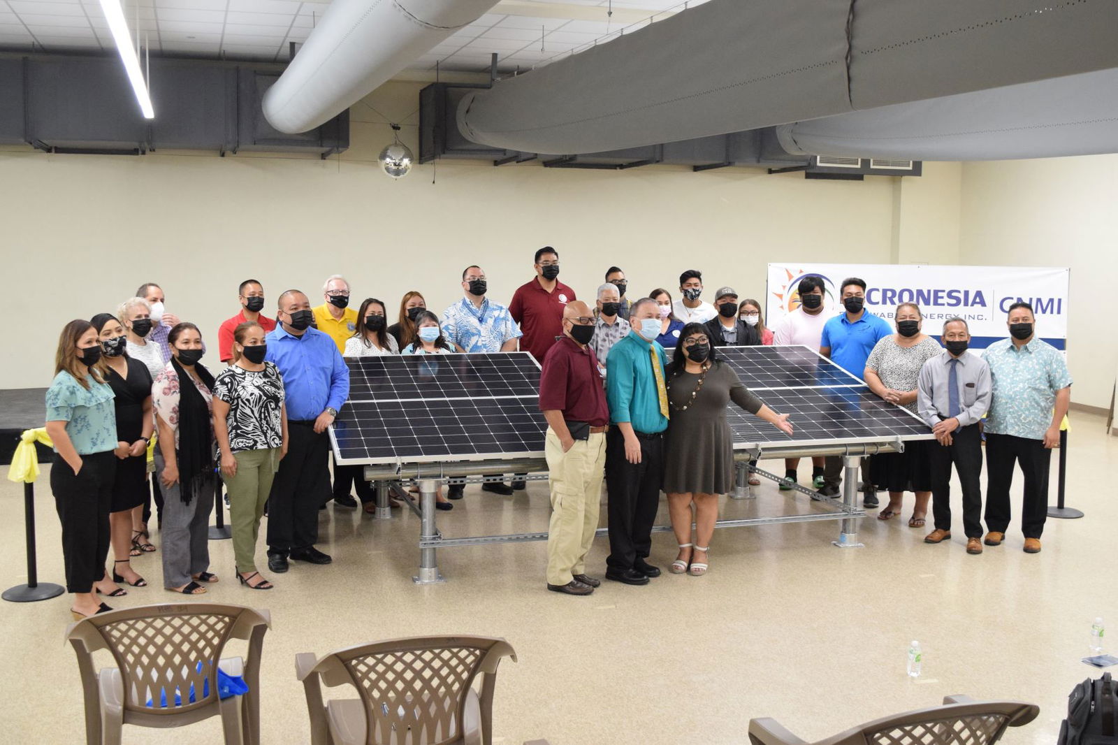 Then-Board of Education Chairman Andrew Orsini, center, poses for a photo with Gov. Ralph DLG Torres, right, Lt. Gov. Arnold I. Palacios, center, back row,  lawmakers and other education officials during the launch ceremony for the  Public School System’s solar energy system at Marianas High School on Oct. 7, 2021.
