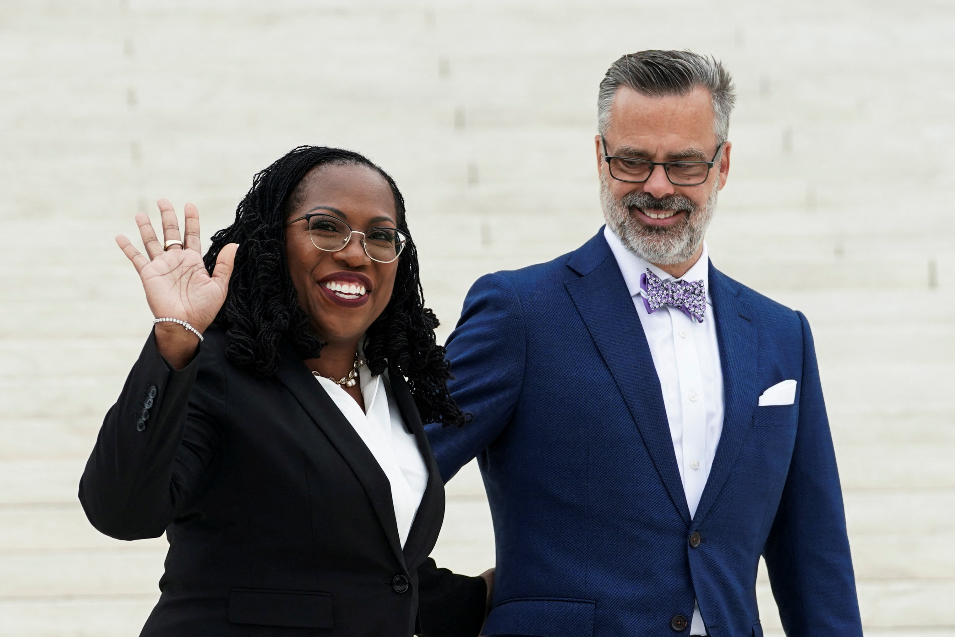 U.S. Supreme Associate Justice Ketanji Brown Jackson waves with her husband, Dr. Patrick Jackson, during a photo opportunity outside the U.S. Supreme Court following an investiture ceremony for Justice Jackson in Washington, D.C., Sept. 30, 2022.