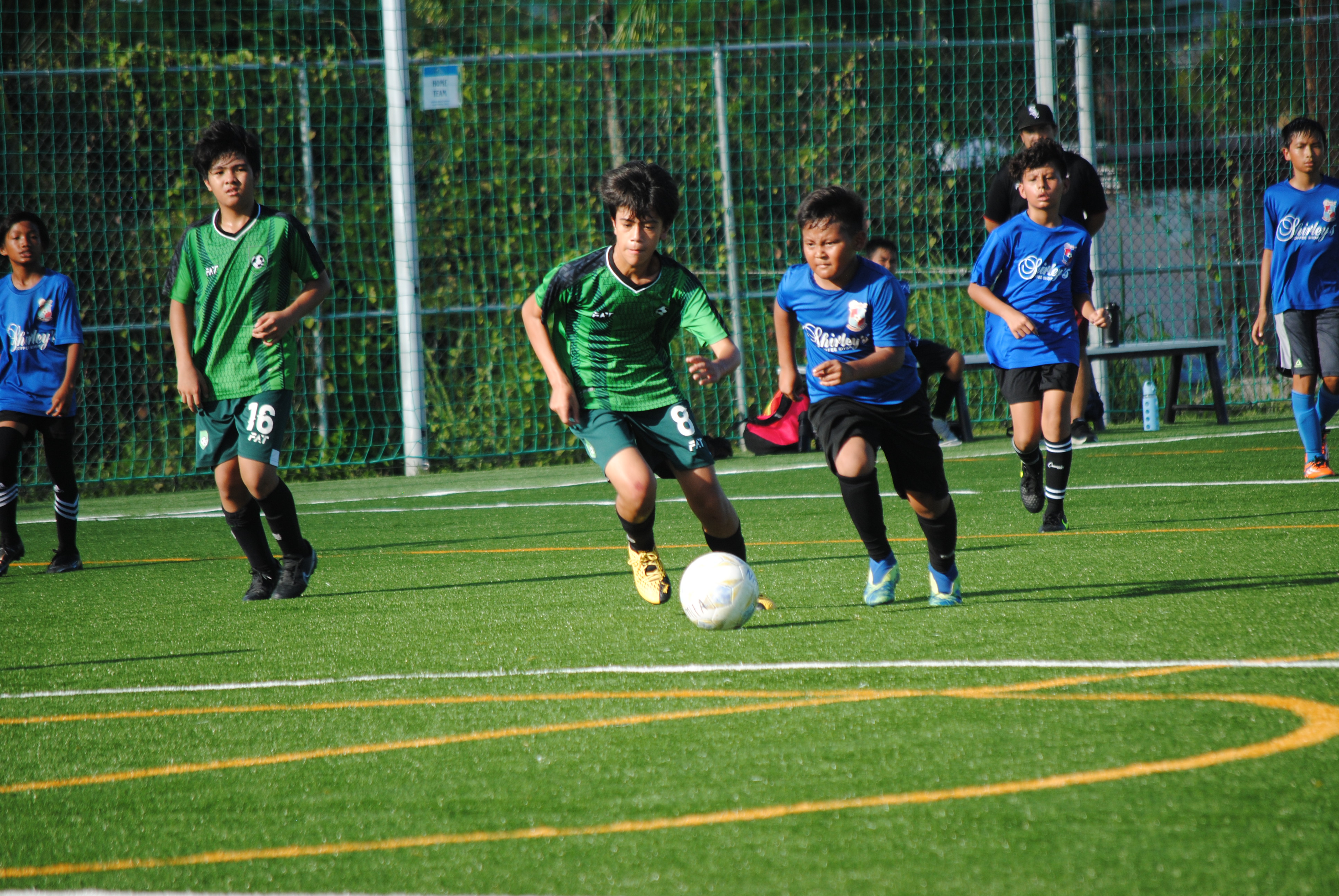 Tan Holdings’ Rafael De Belen and Shirley’s Izaiah Haro race for the possession during a U13 Boys Division game of the TakeCare Youth Soccer League Saturday at the NMI Soccer Training Center.