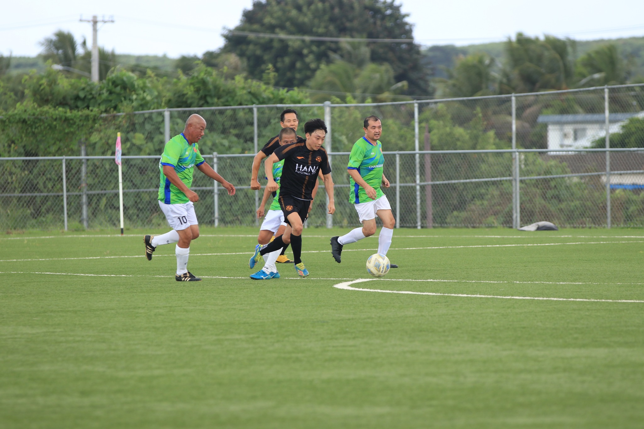 Hana's Hee Kang dribbles past a group of defenders during a Division B game of the Marianas Soccer League at the NMI Soccer Training Center.