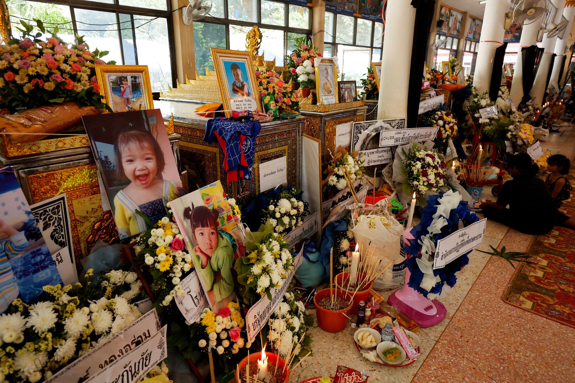 Tributes and offerings are placed near the coffins of victims at Wat Rat Samakee temple following a mass shooting in the town of Uthai Sawan, Nong Bua Lam Phu province, Thailand, Oct. 8, 2022.