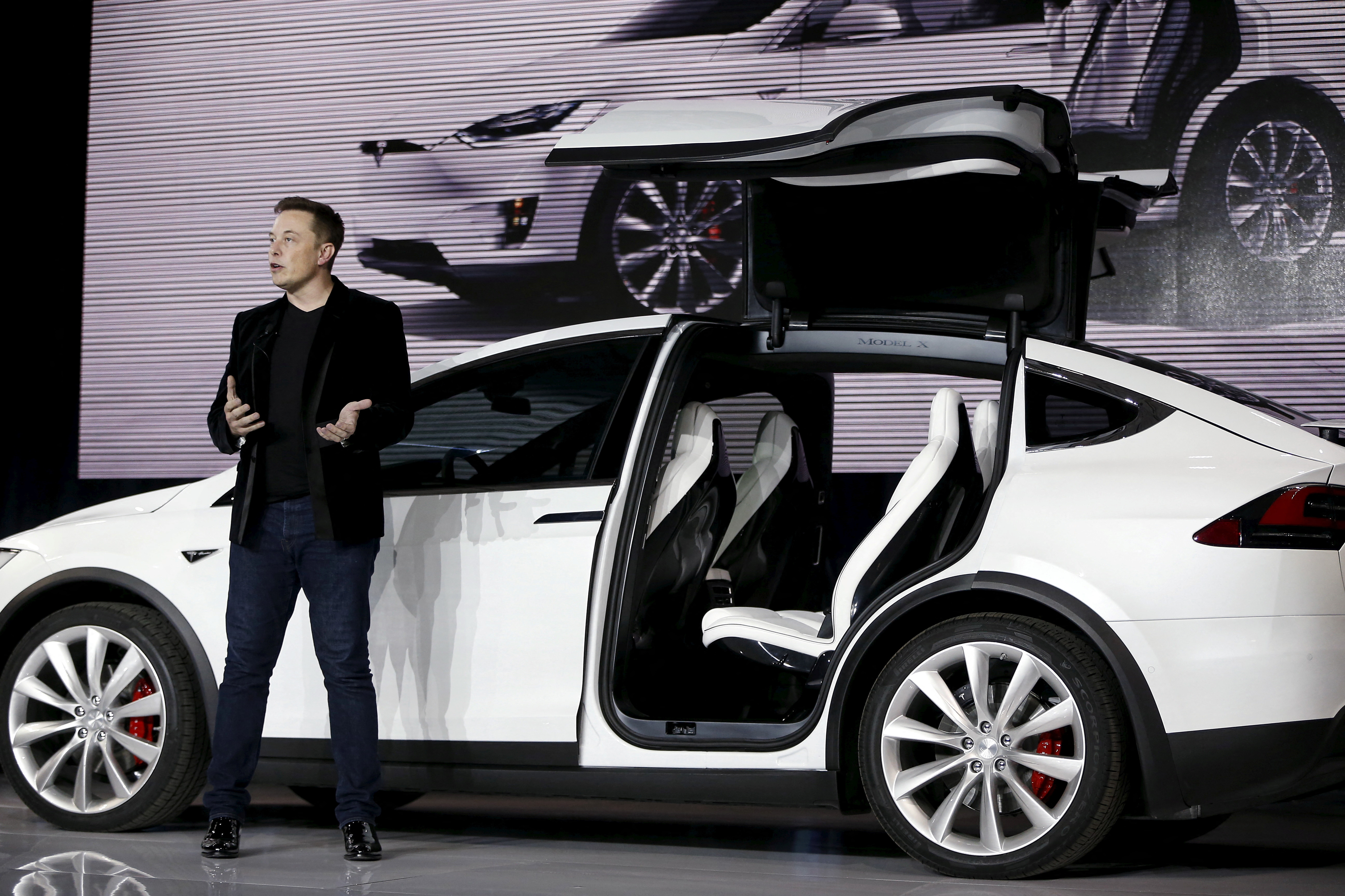 Tesla Motors CEO Elon Musk introduces the falcon wing door on the Model X electric sports-utility vehicles during a presentation in Fremont, California, Sept. 29, 2015.