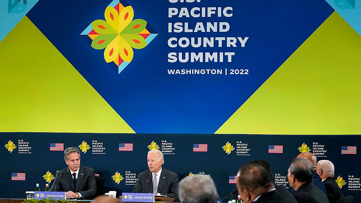 President Joe Biden speaks during the first U.S.-Pacific Island Country Summit at the State Department in Washington, Sept. 29, 2022. Secretary of State Antony Blinken listens at left.