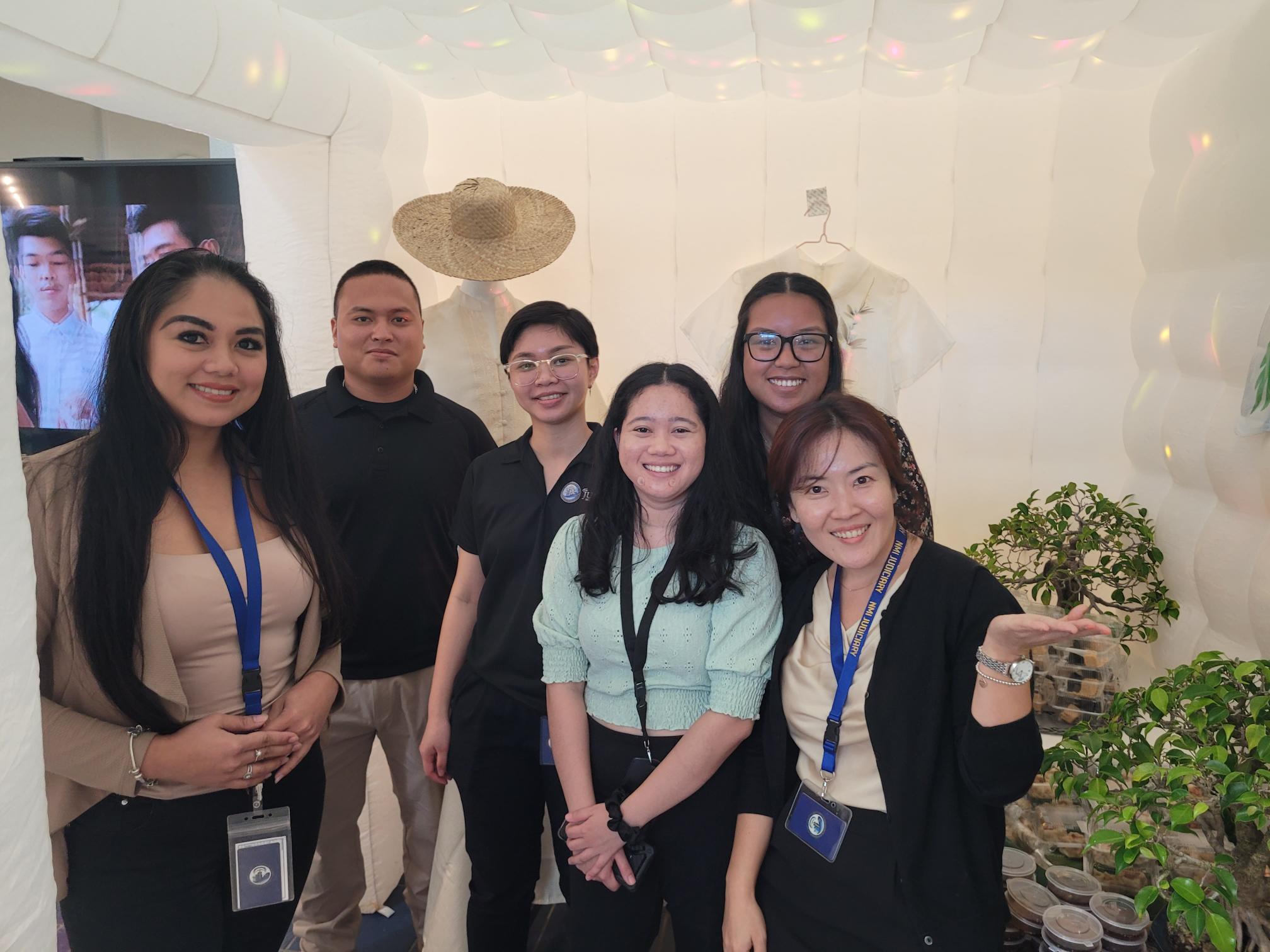 Staffers pose at the Asian-themed booth during the judiciary’s Cultural Day celebration at Guma Hustisia.
