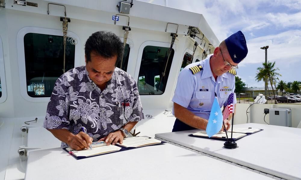 FSM Secretary of Justice Joses R. Gallen and Capt. Nicholas R. Simmons sign the expanded shiprider agreement.