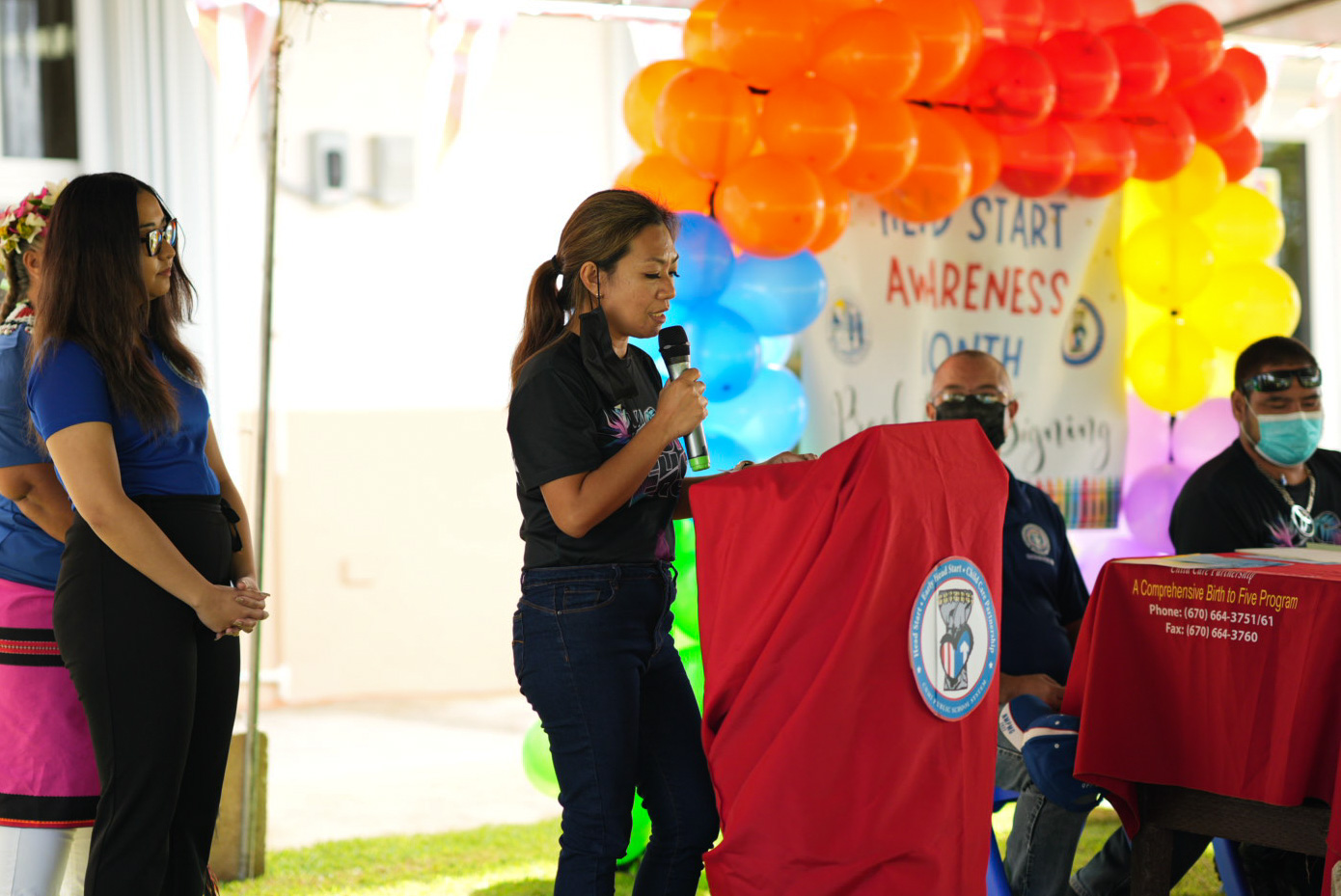 2022 Head Start Teacher of the Year Kathryn Ramos reads the proclamation. Standing  behind her is 2022 Head Start Teacher Aide of the Year Kayla Borja.