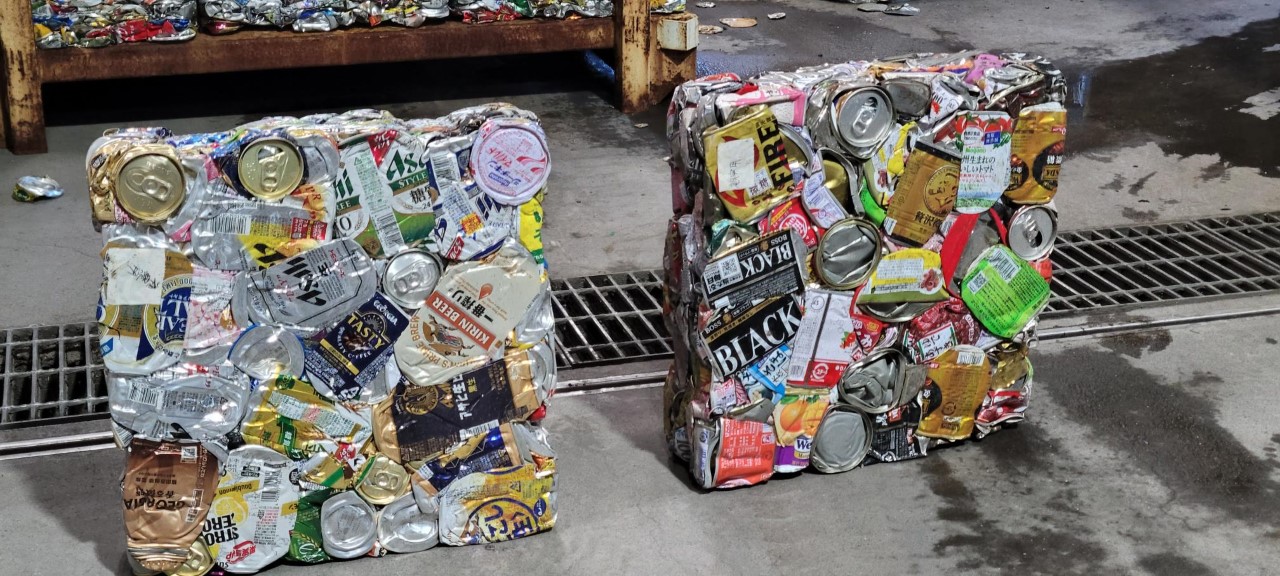 Recycled cans are compacted at a facility, later to be used as materials to form new products.