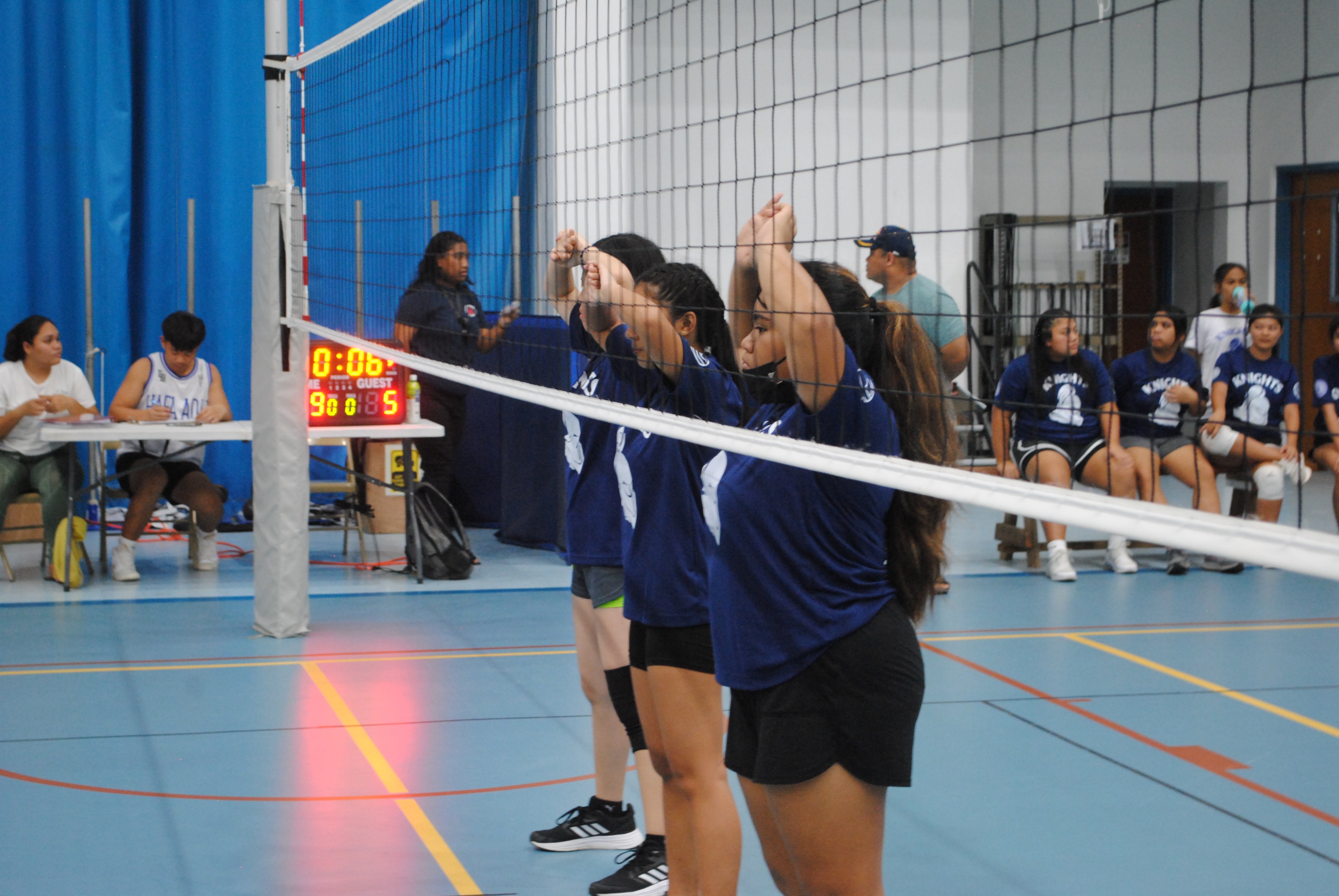 MCS JV players set up to receive an incoming serve during an NMIVA-PSS Girls High School Volleyball SY22-23 game at the MHS gym.