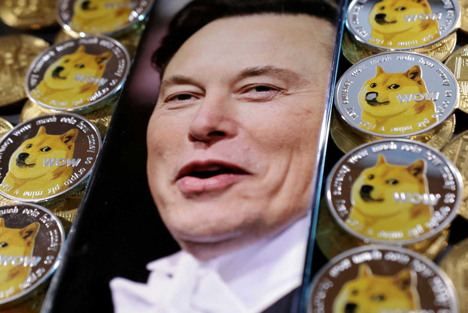 A photo of Elon Musk is displayed on a smartphone placed on representations of cryptocurrency Dogecoin in this illustration taken on June 16, 2022.