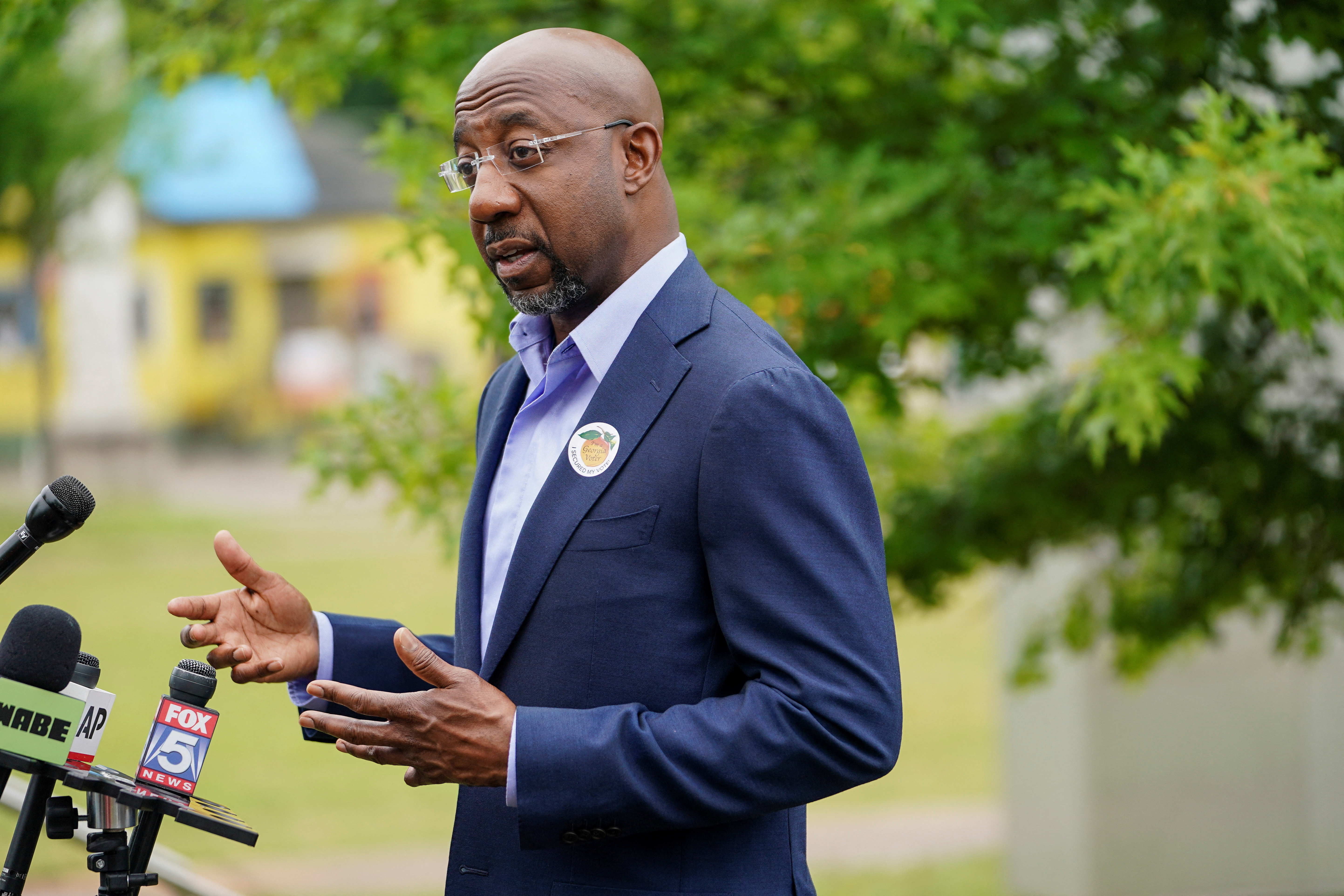 U.S. Sen. Raphael Warnock, D-GA, speaks at a press conference at a Fulton County polling station in Atlanta, Georgia, May 6, 2022.