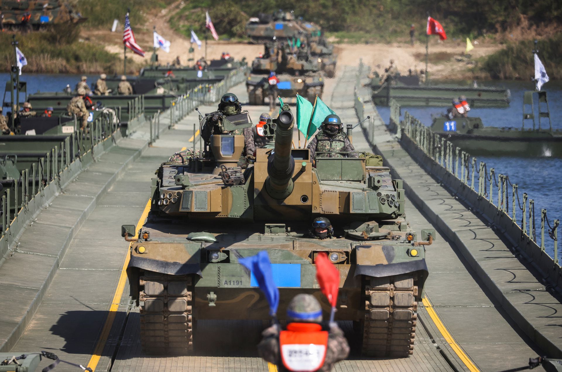 A South Korean soldier guides the tanks taking part in a joint river crossing operation drill between South Korean and U.S. troops, in Yeoju, South Korea, Oct. 19, 2022.