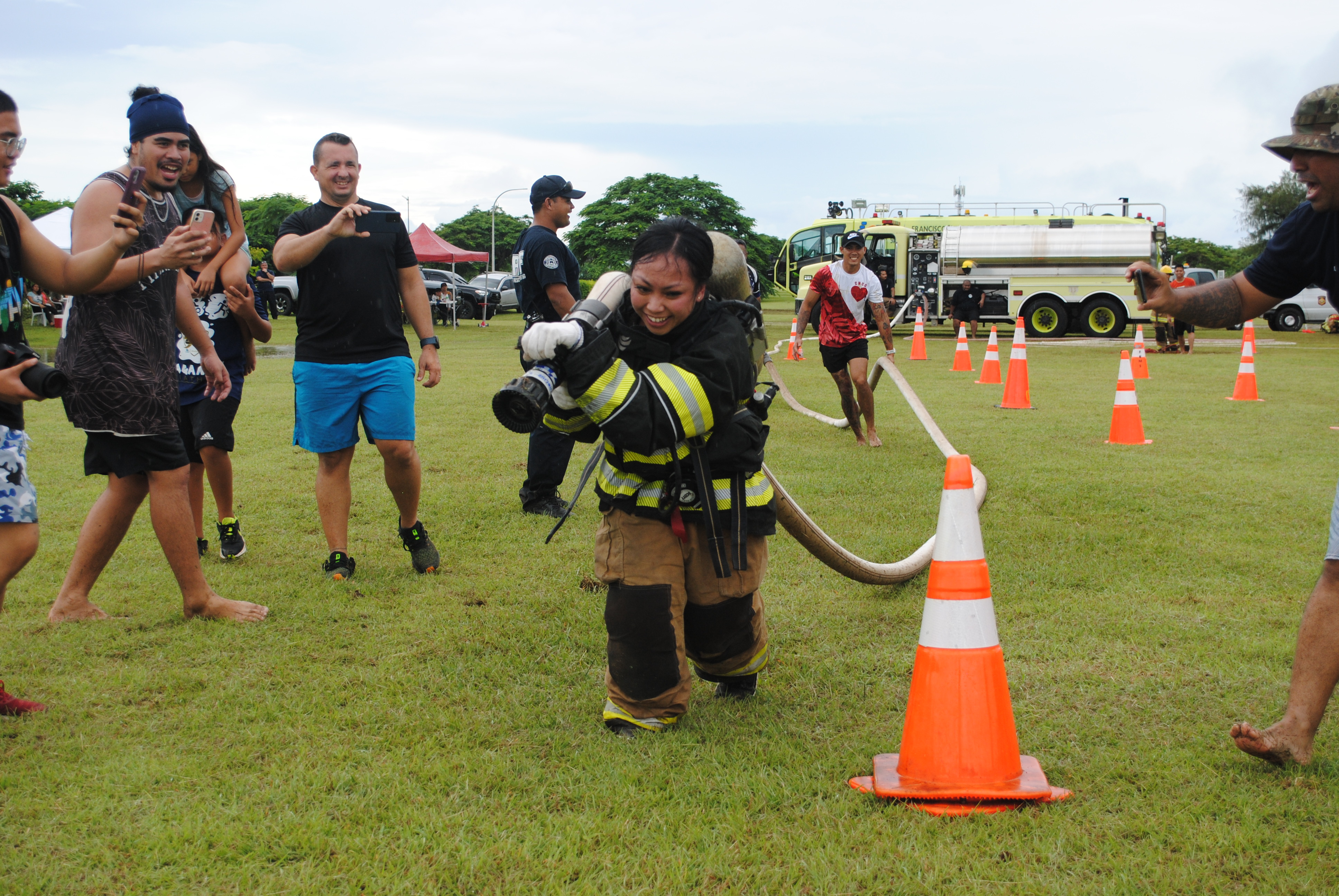 Evelyn Pangelinan drags a firehose through the obstacle course during the Saipan Muster Challenge at the Airport Field on Saturday.