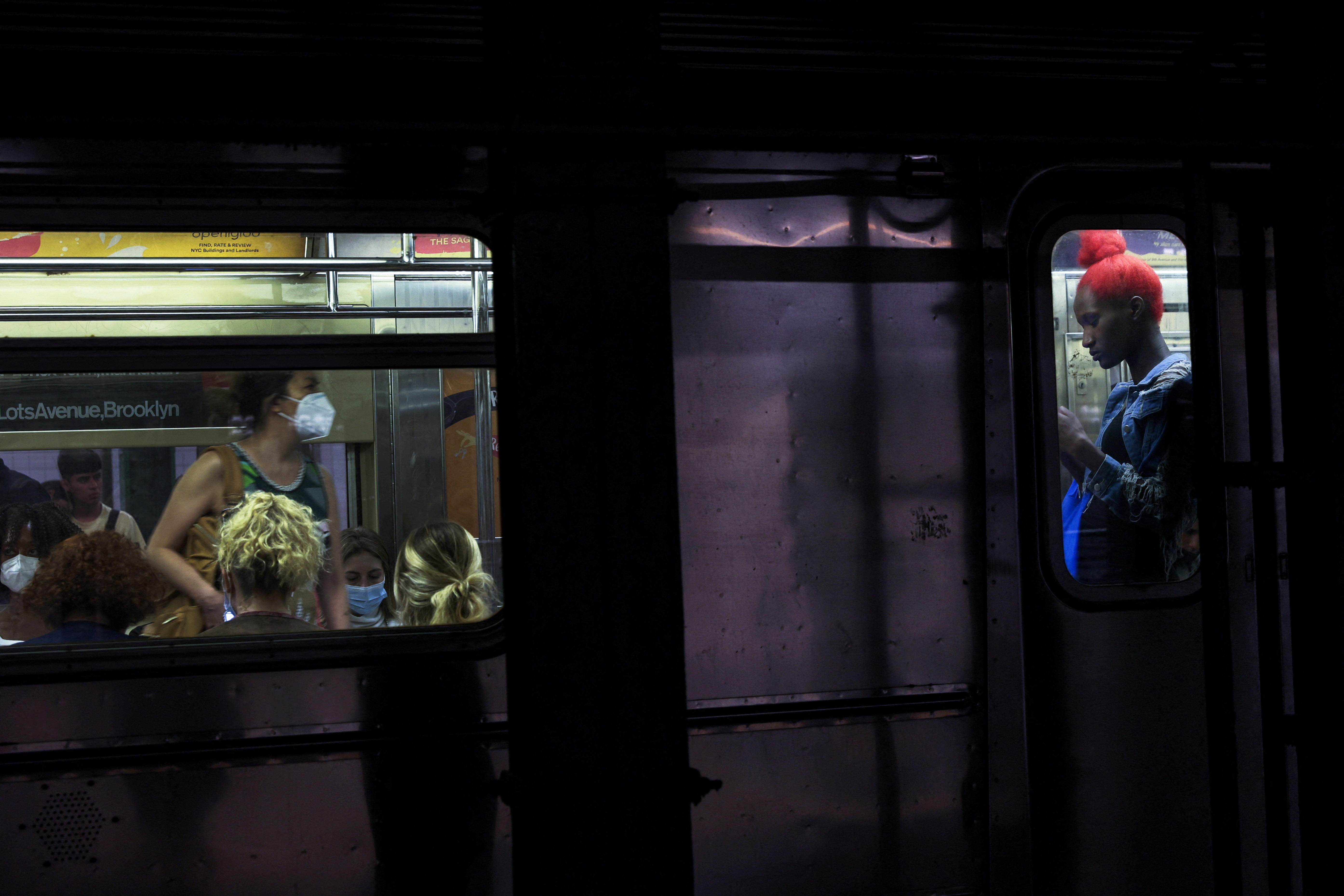 People are seen on board a subway at the 42nd street station in New York City, June 15, 2022.