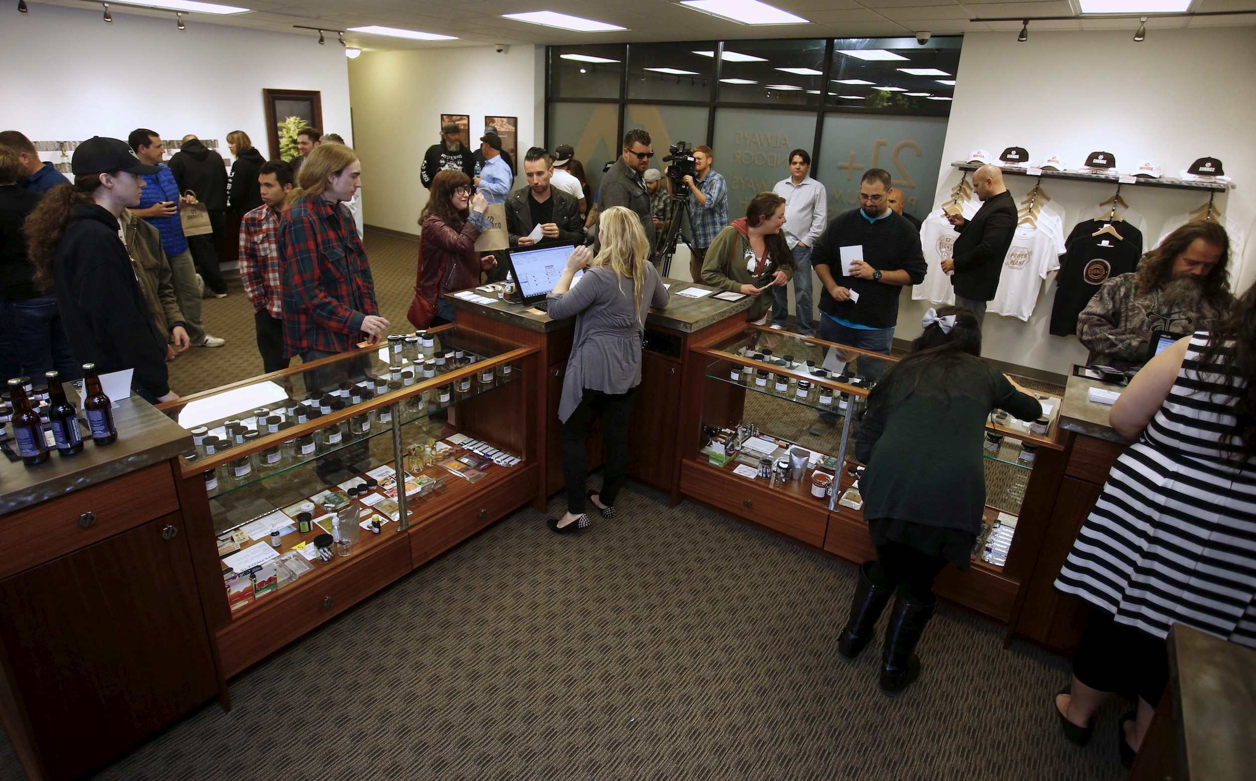 Customers are seen inside Shango Cannabis shop to purchase legal recreational marijuana beginning at midnight in Portland, Oregon on Oct. 1, 2015.