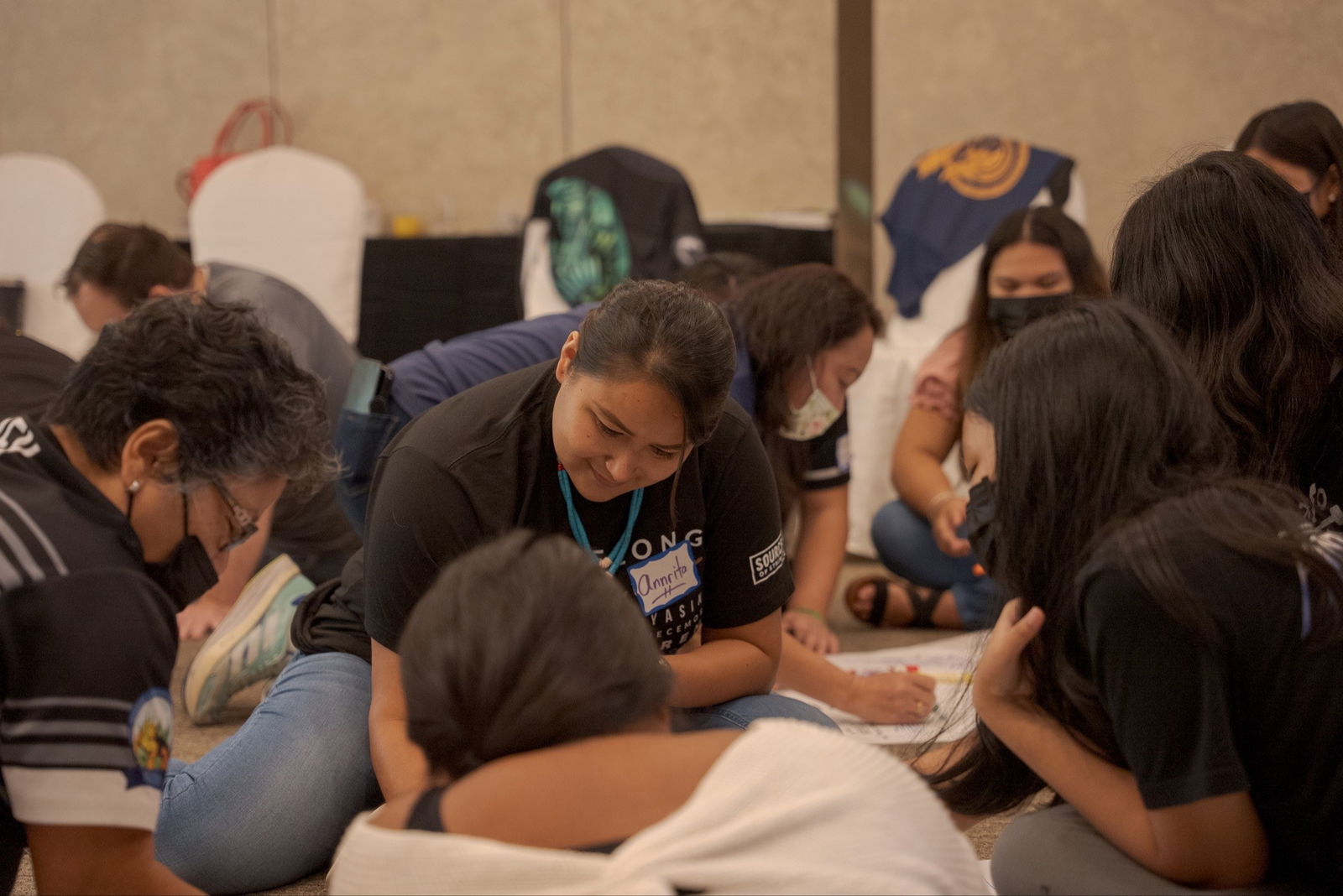Annrita Benavente, behavioral health specialist, and the SOS Training Team work alongside Hopwood Middle School peer leaders and adult advisors Femie Rey and Ma. Jyn Binghit as they visualize their sources of strength for an illustration activity.