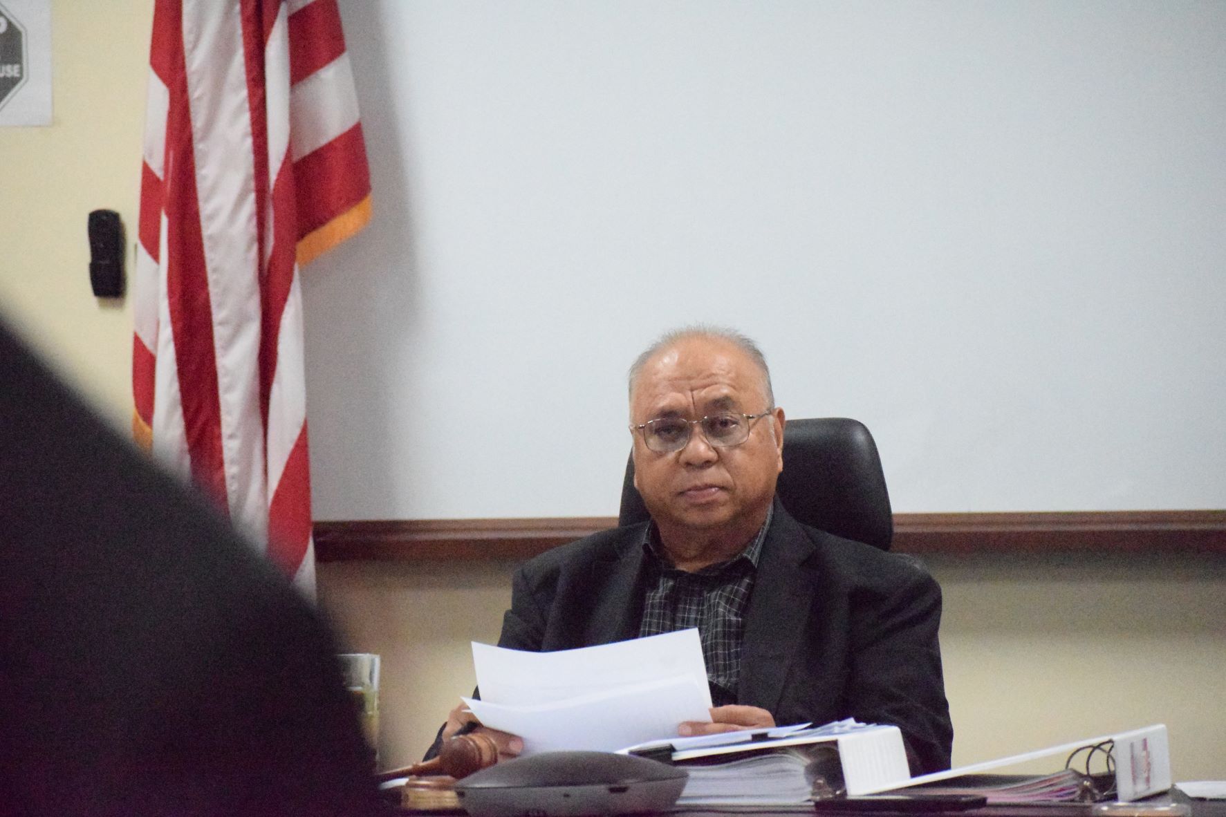 Commonwealth Casino Commission Chairman Edward C. Deleon Guerrero listens to the report of CCC Executive Director Andrew Yeom during  a meeting Thursday at the CCC office in Gualo Rai.