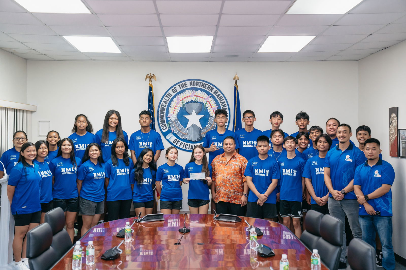 Gov. Ralph DLG Torres poses for a photo with Northern Mariana Islands Basketball Federation officials, team coaches and U15  players after making a donation of $22,453 at the governor’s office on Thursday.
