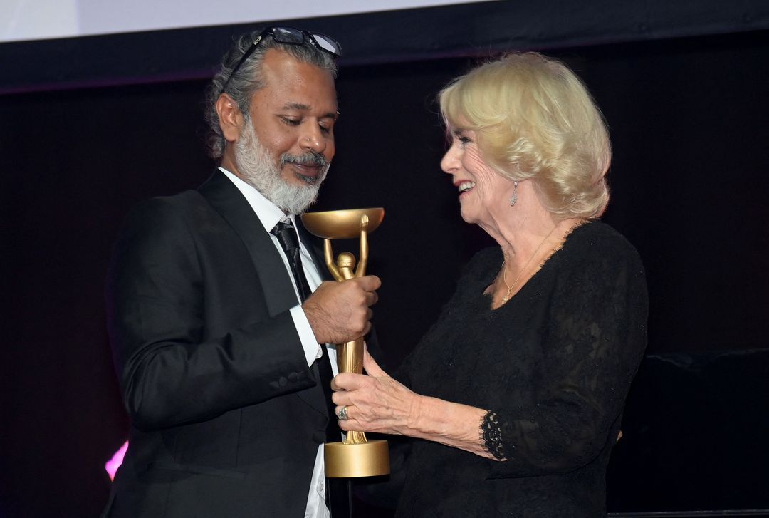 Britain's Queen Consort Camilla presents winner Shehan Karunatilaka with the trophy for "The Seven Moons of Maali Almeida" at the Booker Prize for Fiction 2022 awards ceremony, in London, Britain, Oct. 17, 2022.