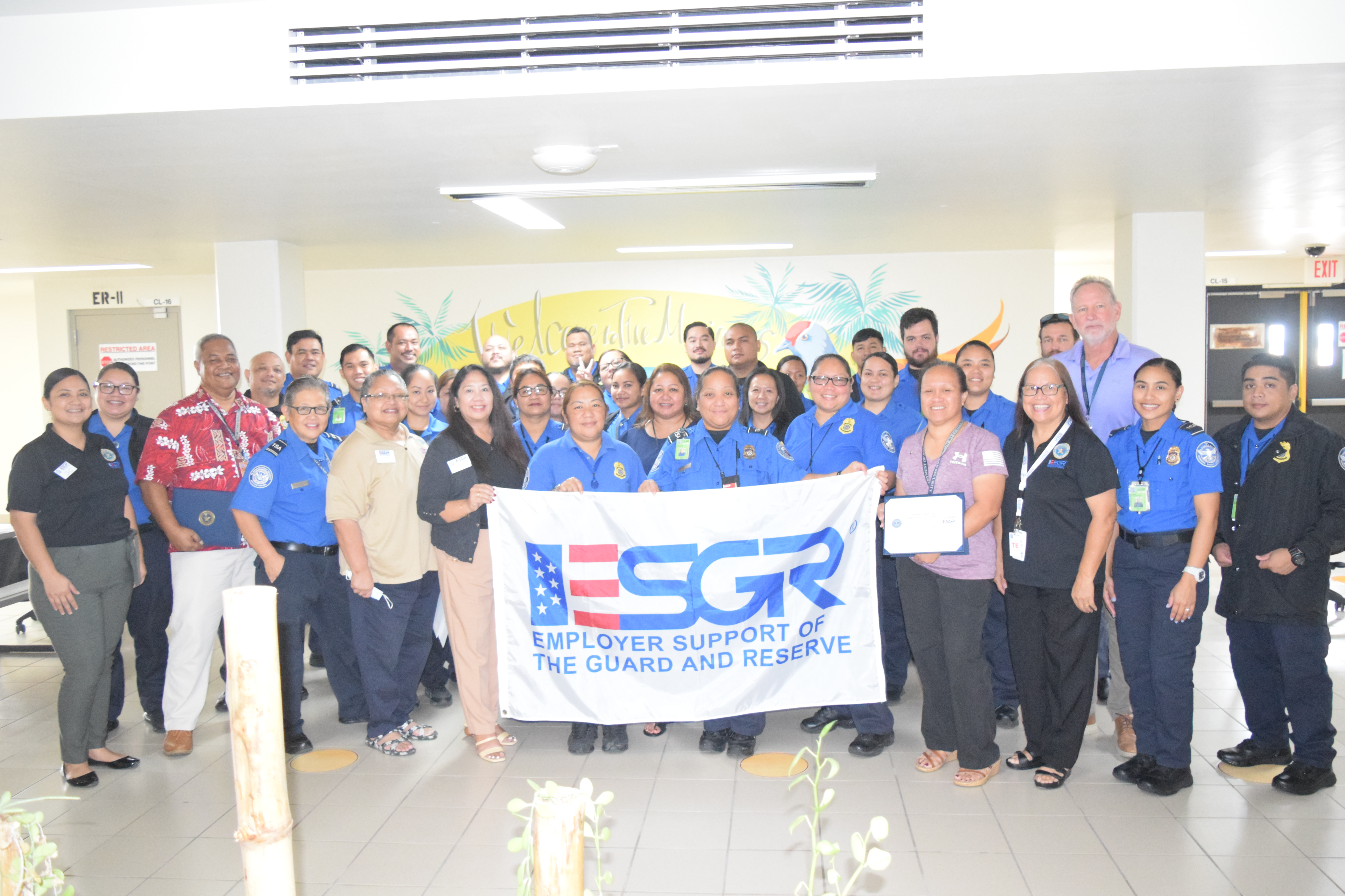 Transportation Security managers Henry Litulumar, third left, and Fausia Dela Cruz, fourth right, with other TSA personnel and  Employer Support of the Guard and Reserve Guam-CNMI Area Chair Rita A. Sablan, Ed.D., third right, Ombudsman Joann Aquino, sixth left, Employer Outreach Coordinator Rose Igitol, fifth left, and volunteer Joshlyn Blas, left, at the Francisco C. Ada/Saipan International Airport on Tuesday.