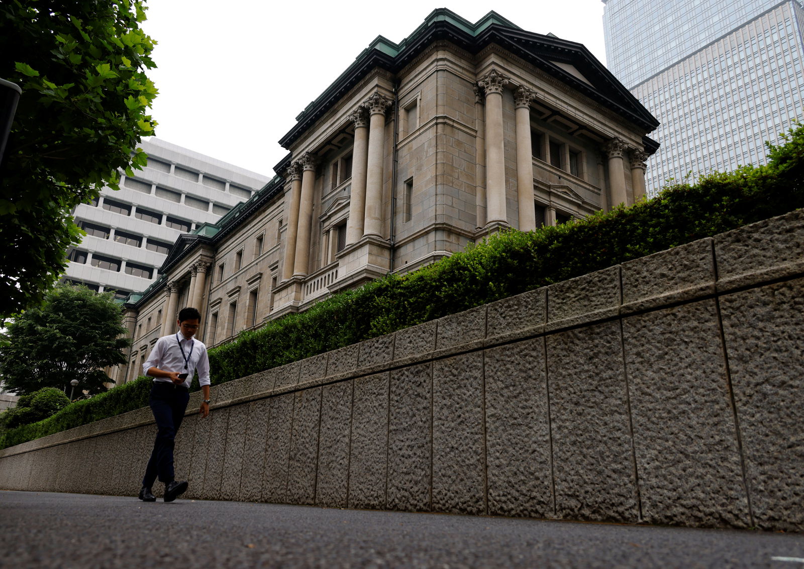 A man walks past Bank of Japan's headquarters in Tokyo, Japan, June 17, 2022.