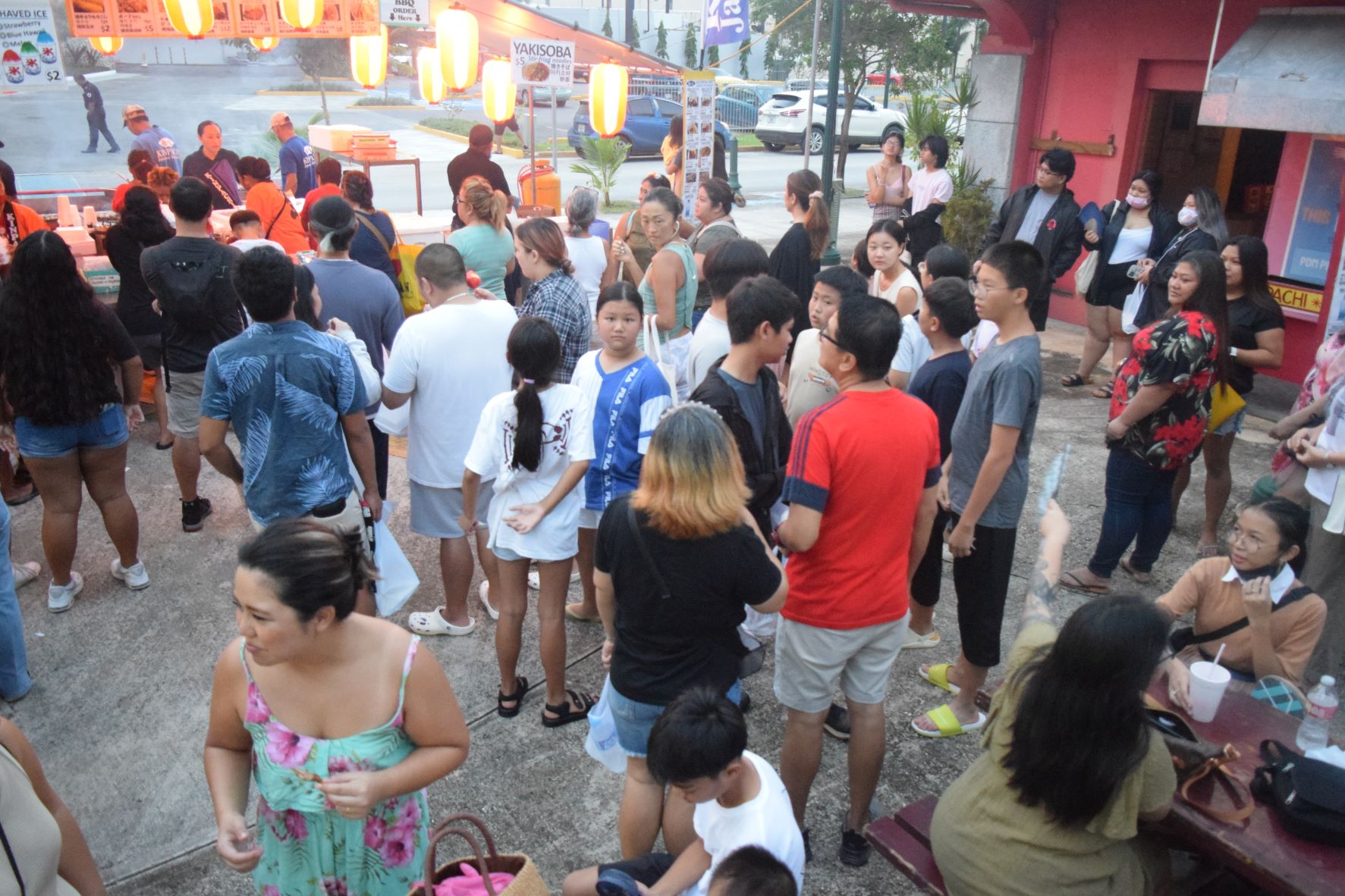 Community members wait for their turn to purchase food from vendors during the Japanese Autumn Festival at the Paseo De Marianas on Saturday.