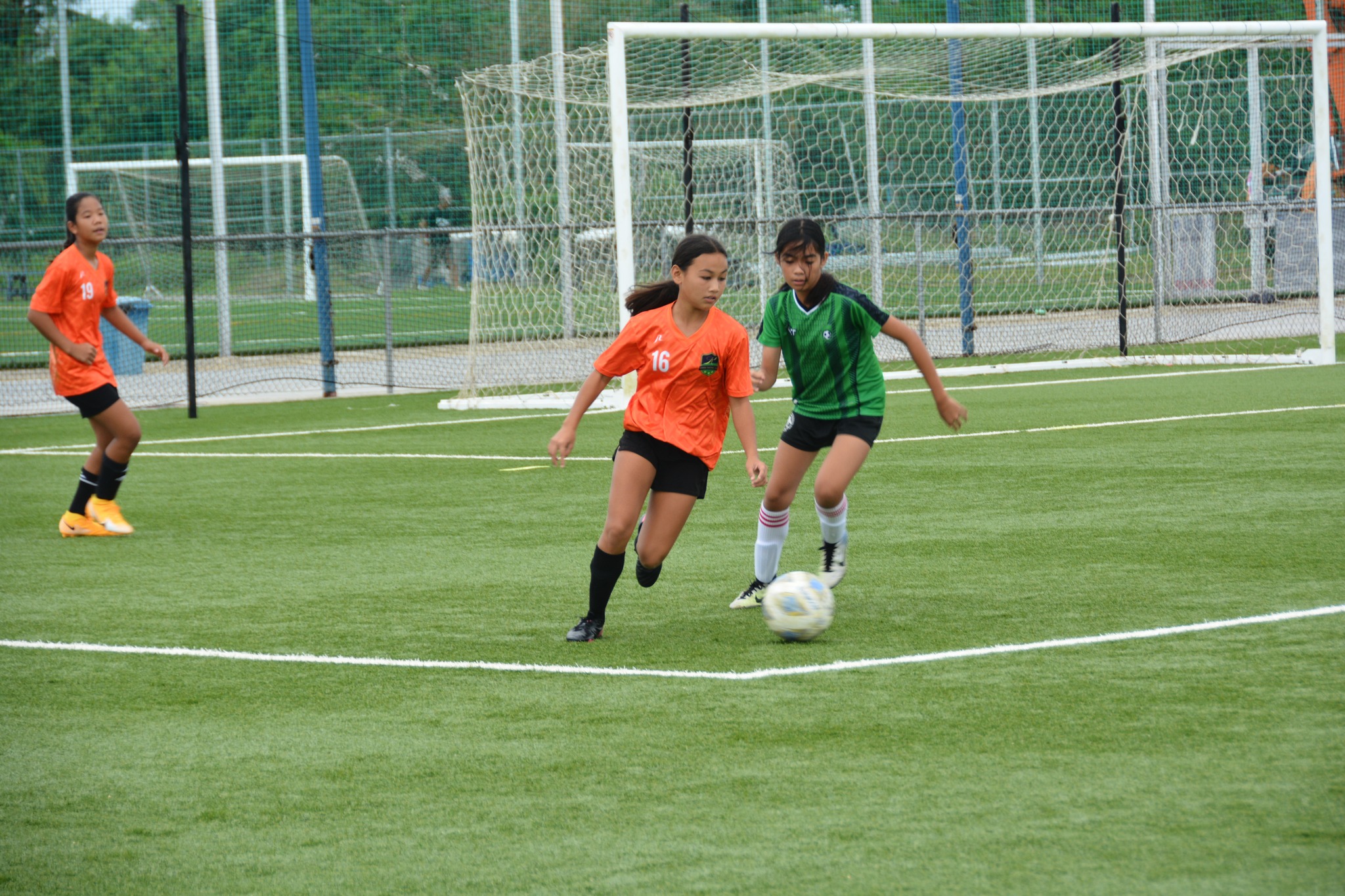 Kanoa 1's Aubrey White and a defender go after the ball during a U13 girls division game of the TakeCare Youth Soccer League at the NMI Soccer Training Center.