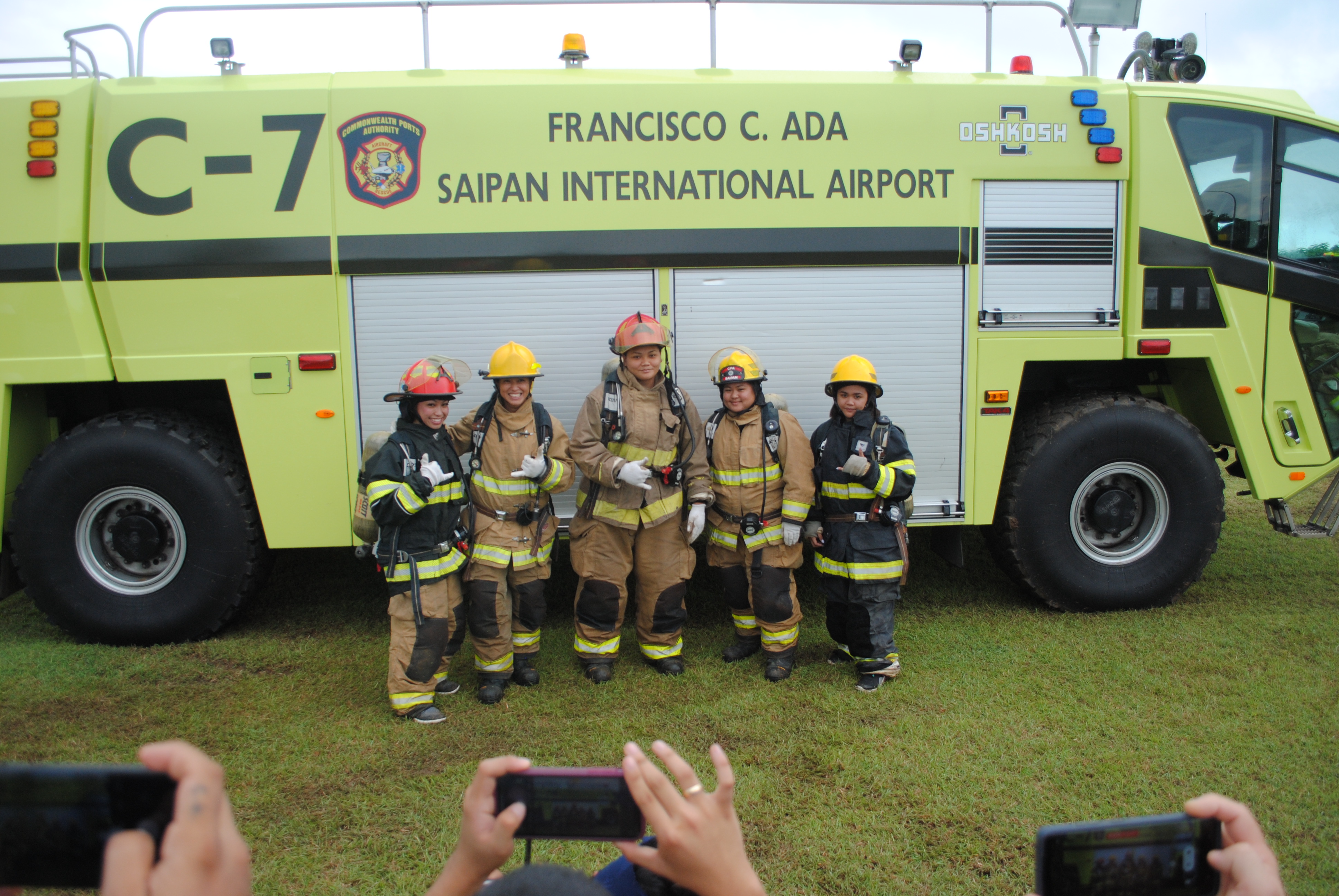 The women's team members pose for a photo before taking on the course during the Saipan Muster Challenge at the Airport Field on Saturday.
