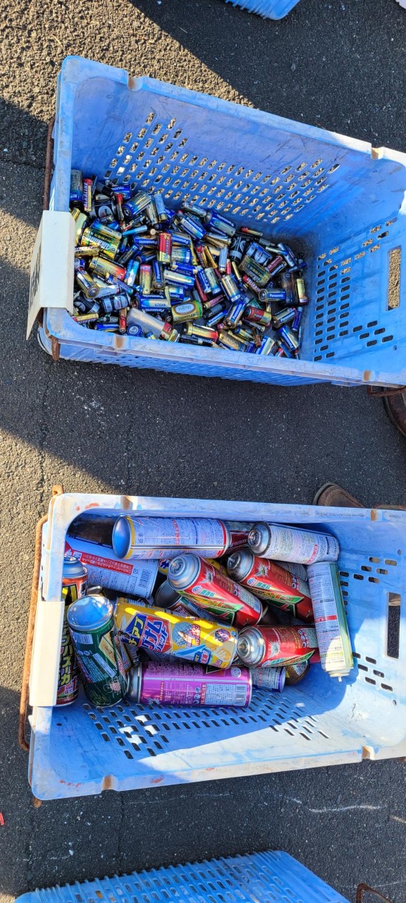 Recycled items, such as used batteries and canisters, are sorted into blue bins at designated sites across Osaki town.