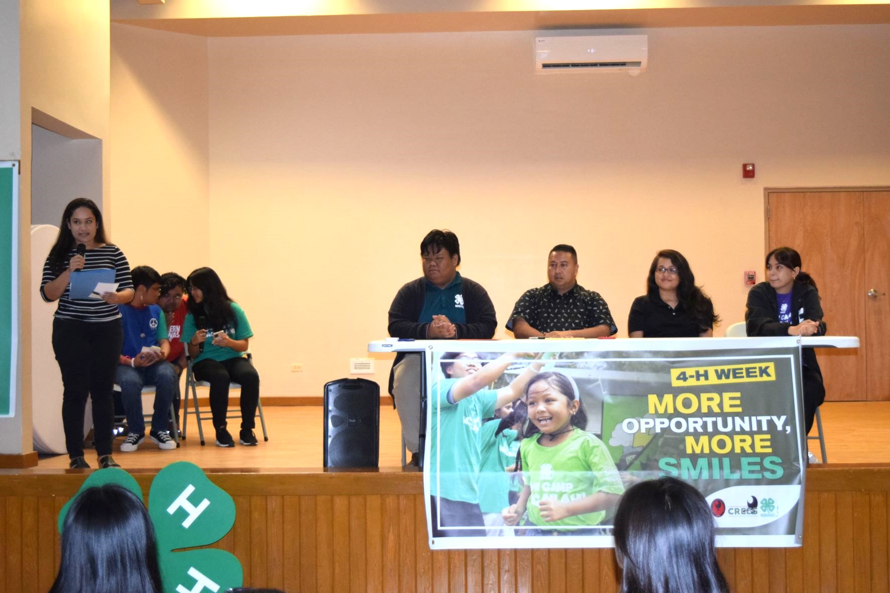 Natasha Nogis Tomokane, left, speaks during the proclamation signing for National 4-H Week at the Kagman Community Center on Wednesday. Also in photo are Gov. Ralph DLG Torres, second left seated, 4-H Marianas Youth State Council President Rownel Jody Coloma, left seated, 4-H Saipan Youth Council Vice President Raina Avelino, right, and Northern Marianas College-Cooperative Research, Extension and Education Services Interim Dean Patricia Coleman, second right.