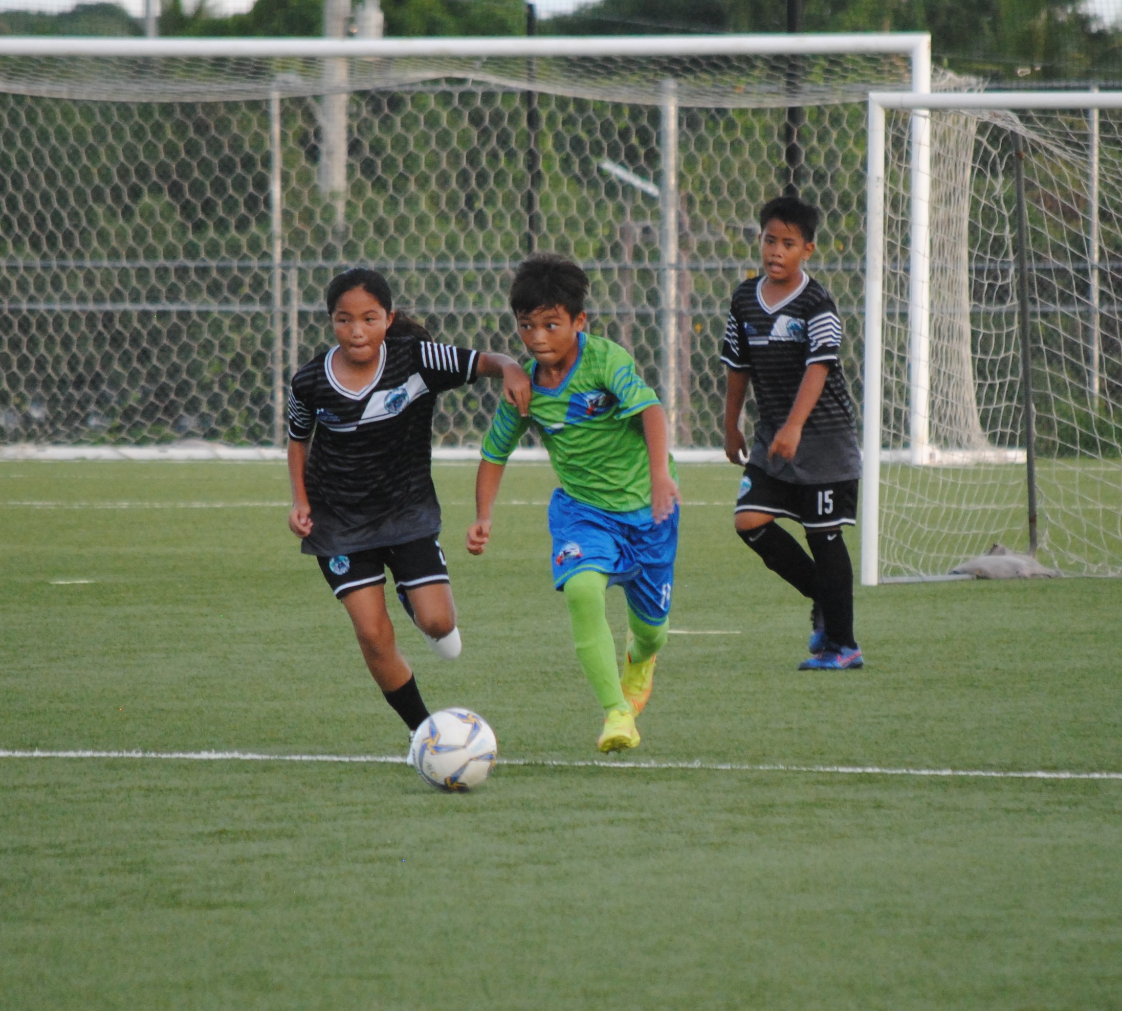 WSR 2's Joshua Lizama battles for possession against a GES 2 player during the elementary school division championship match of the NMIFA-PSS Interscholastic Soccer League at the NMI Soccer Training Center.