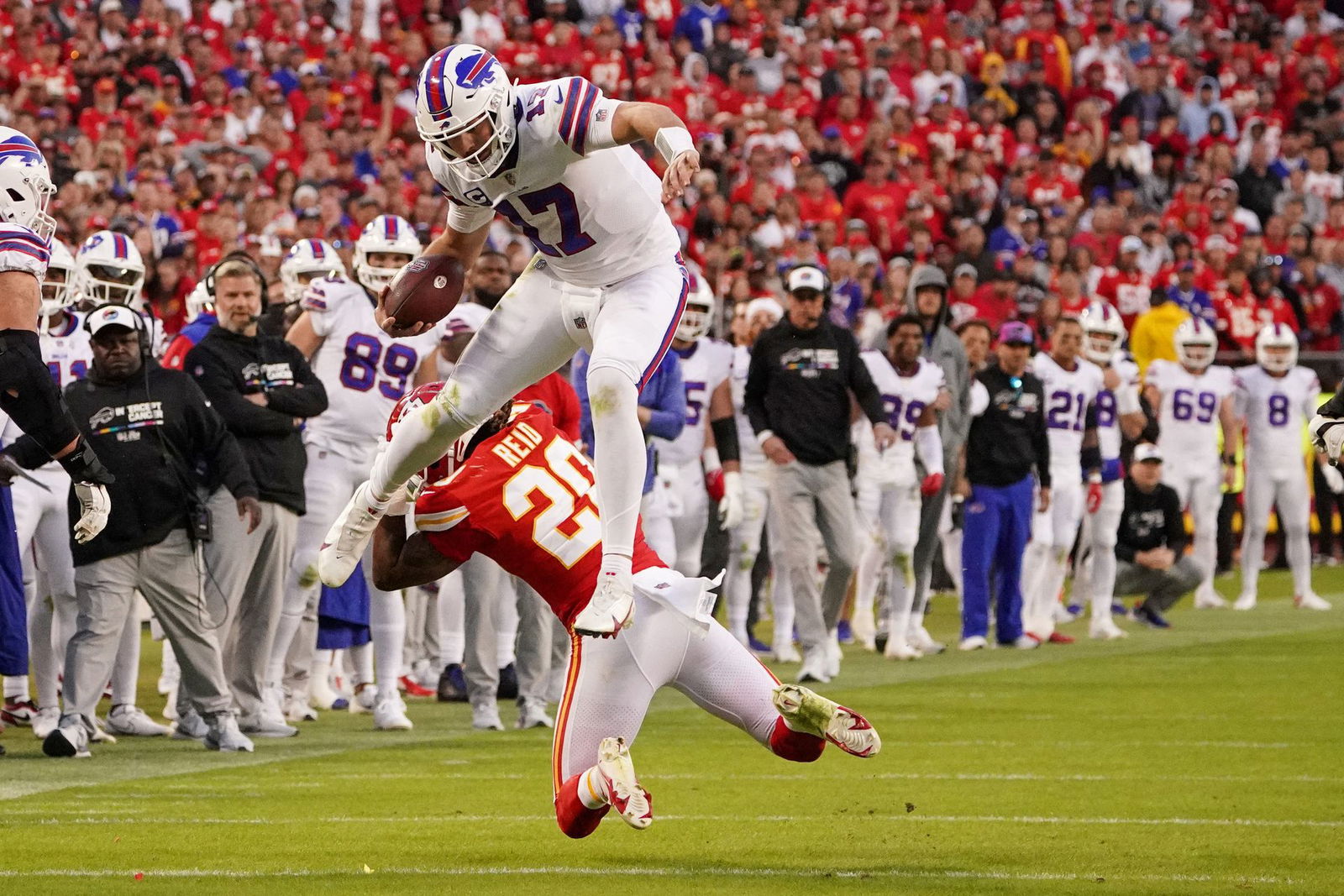 Buffalo Bills quarterback Josh Allen (17) leaps over Kansas City Chiefs linebacker Nick Bolton (32) during the second half at GEHA Field at Arrowhead Stadium in Kansas City, Missouri, Oct. 16, 2022.